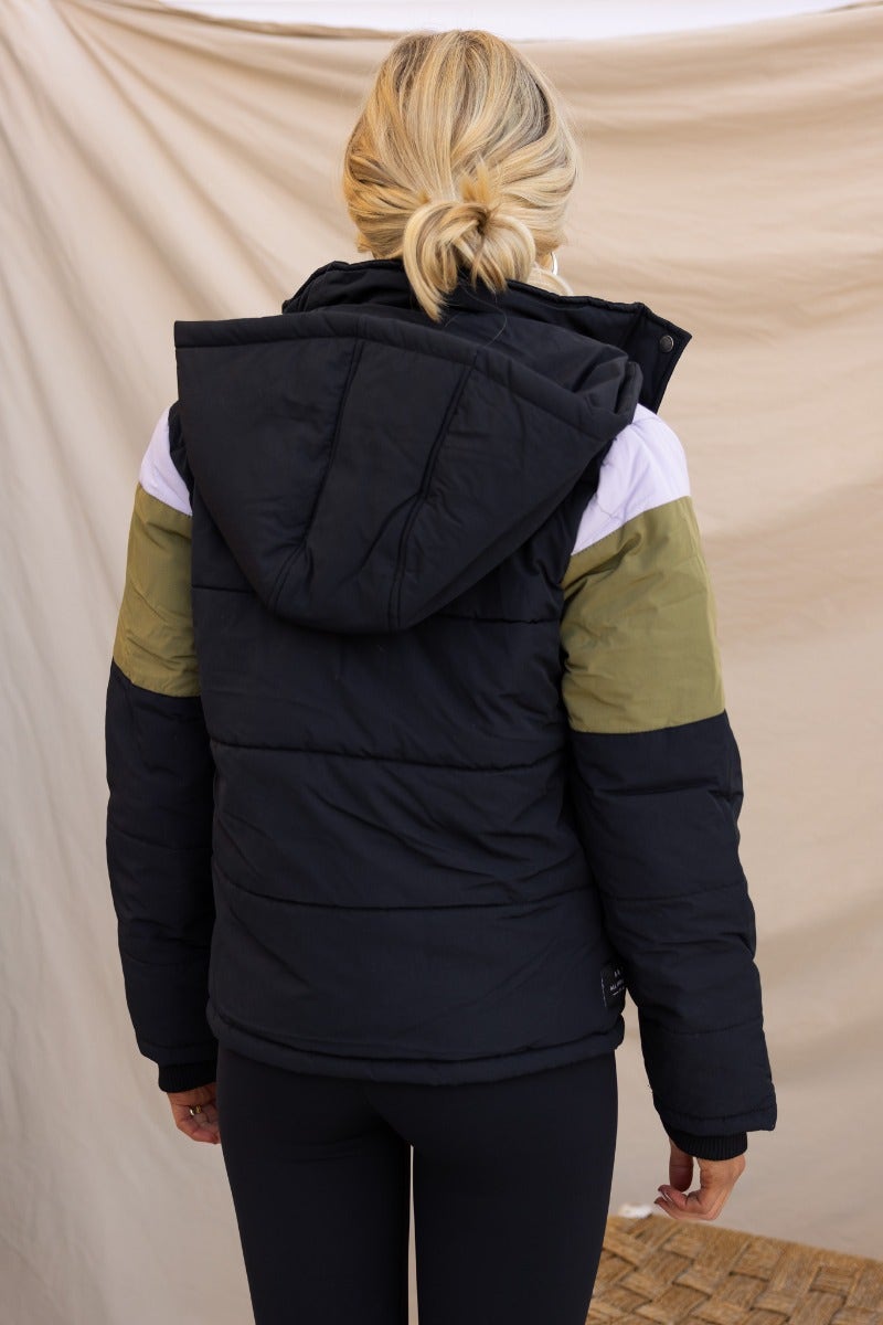 Back view of Charis Puffer Jacket featuring a removable hood and multi-colored accent sleeves, ideal for winter wear.