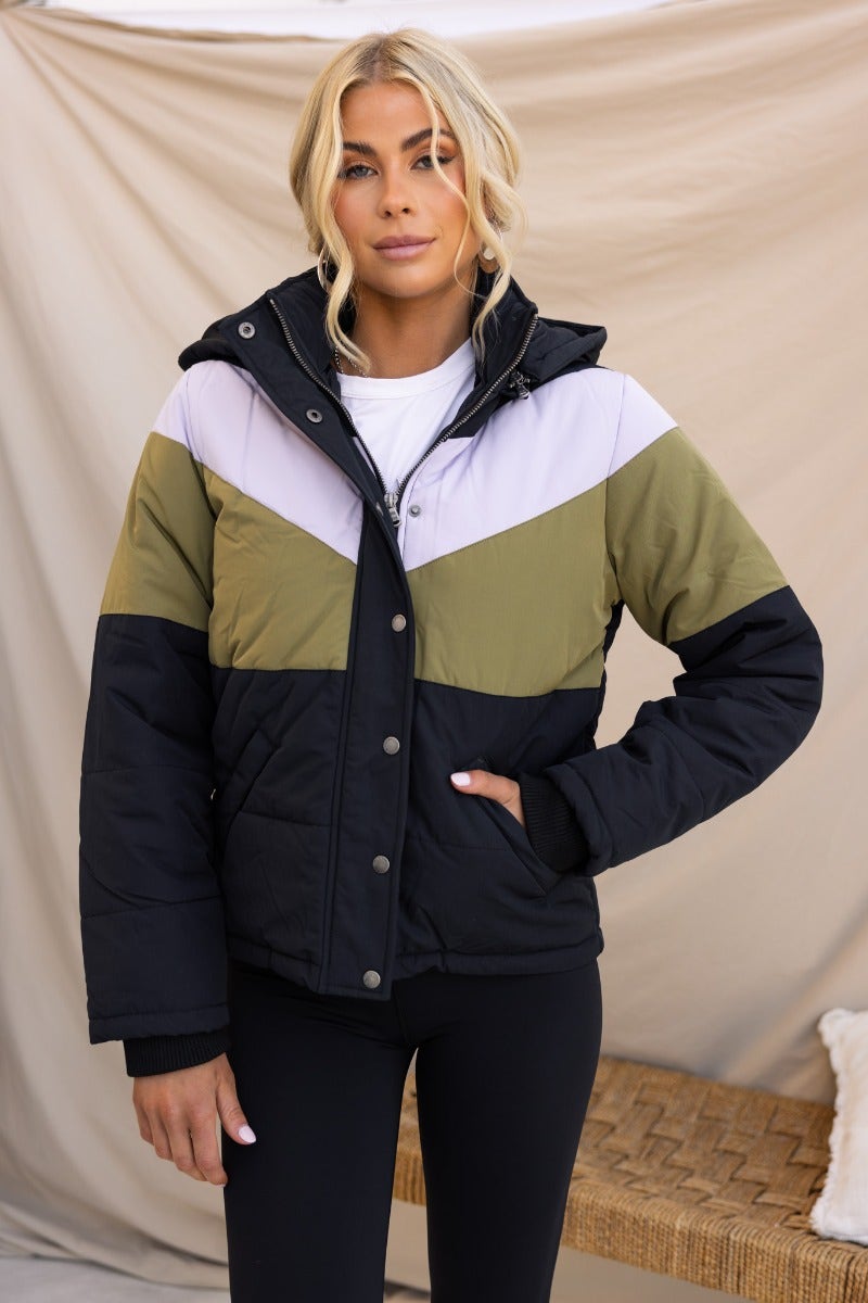 Charis Puffer Jacket in black, olive, and lavender with removable hood and zip button-up front.