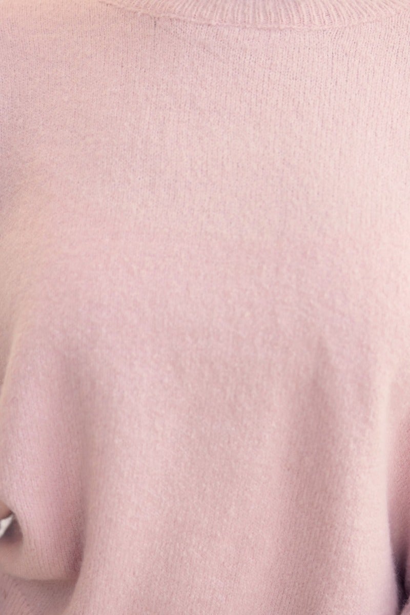 Close-up of Keilor Jumper in soft pink, showcasing round neckline and open weave knit detail, perfect for relaxed style.