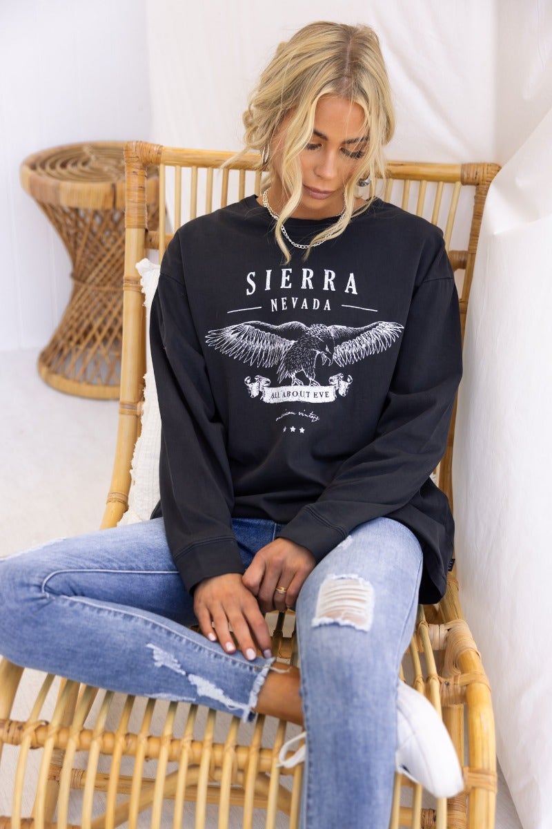 Model wearing oversized Sierra Nevada print long sleeve top by All About Eve, styled with distressed jeans.