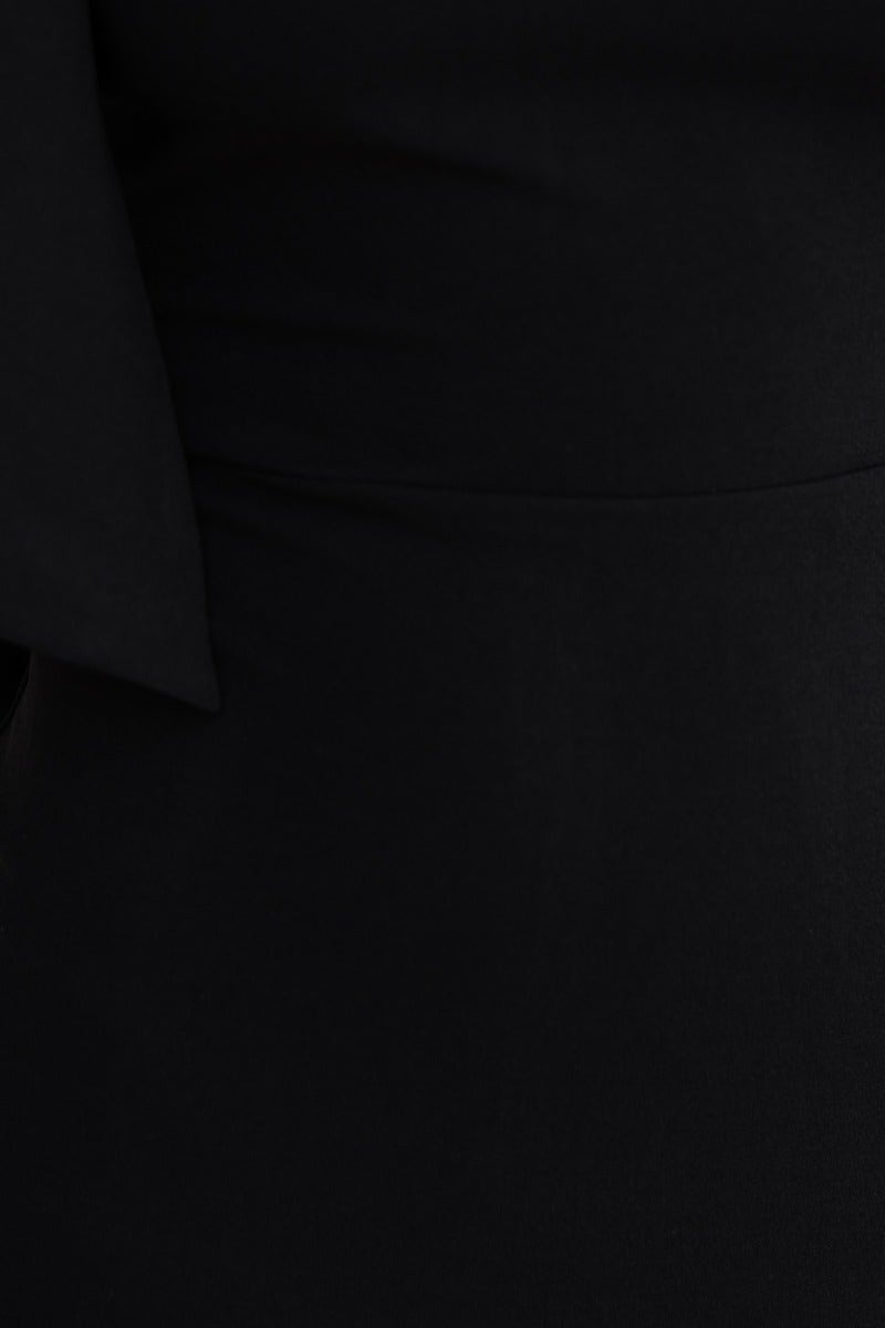 Close-up of the bow detail on the Ellidy midi dress, showcasing its elegant black fabric and one-shoulder design.