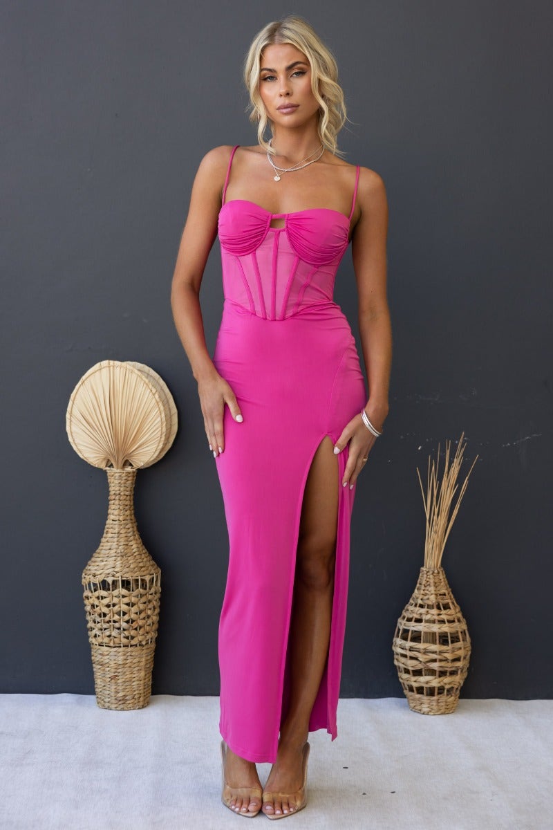 Havilah Midi Dress in vibrant pink with padded bust, sheer mesh waist panel, and front split, styled on model.