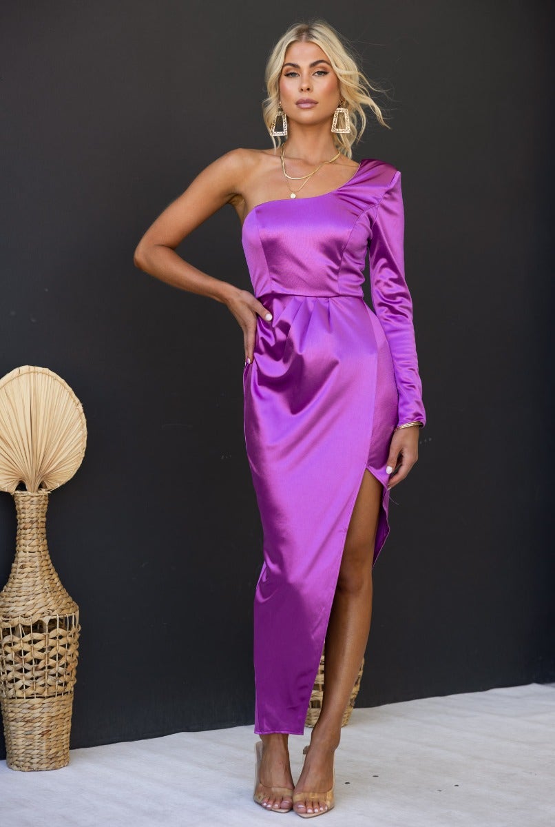 Rommey Maxi Dress in metallic purple with one-shoulder neckline and asymmetrical hemline, styled for a chic look.