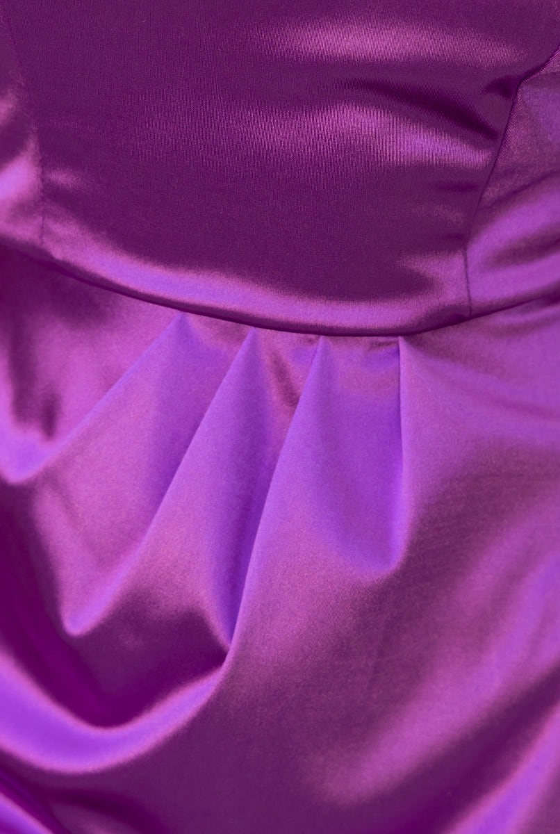 Close-up of the Rommey Maxi Dress in vibrant purple metallic fabric, showcasing pleats and luxurious texture.