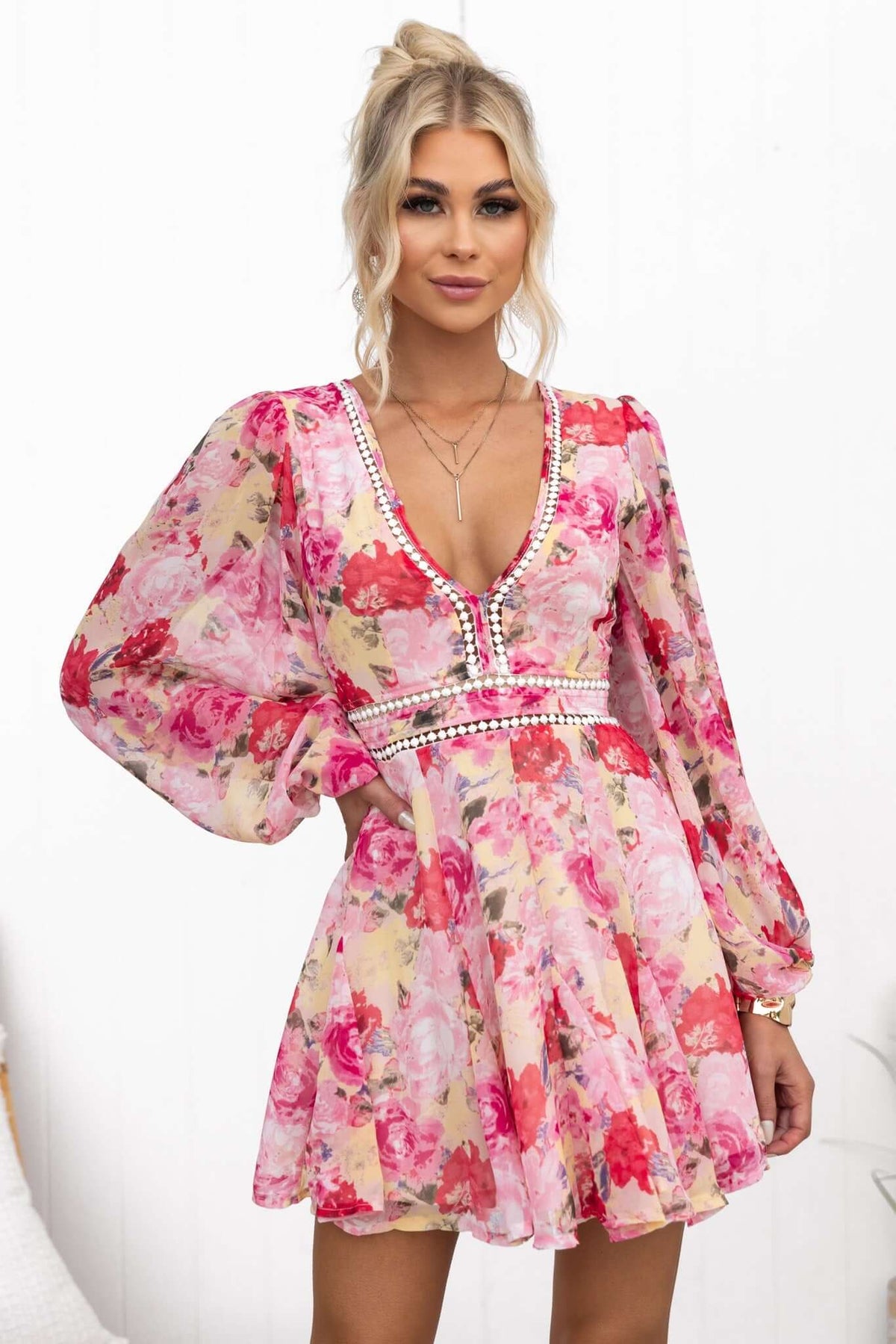 Model wearing the Be My Shine Dress, a floral chiffon dress with a V-neckline and puffed sleeves.