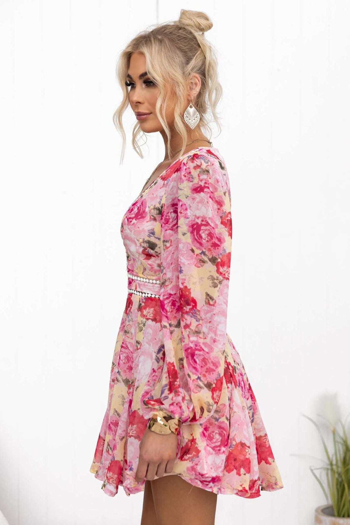 Side view of the Be My Shine Dress featuring floral print, V-neckline, and flutter sleeves, perfect for spring or summer.