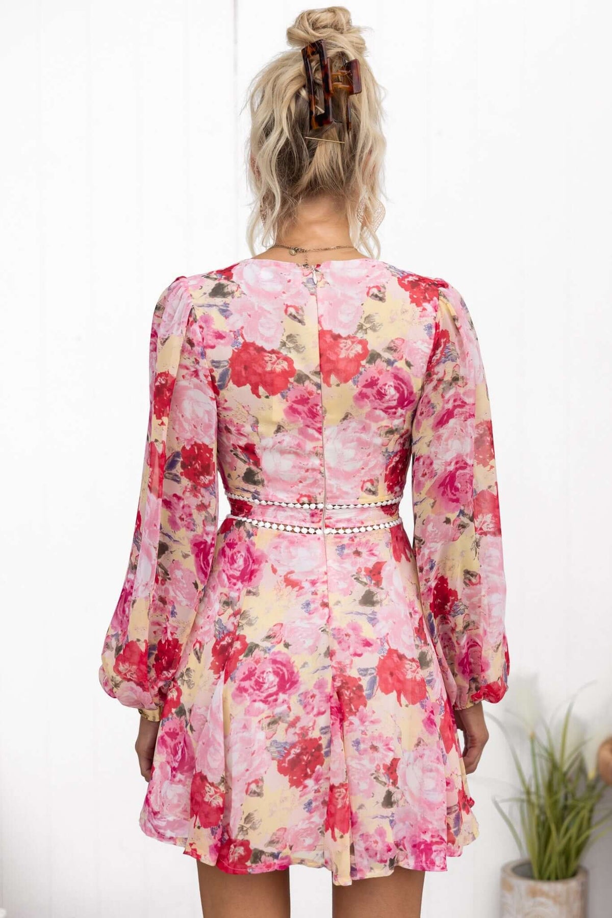 Back view of Be My Shine Dress featuring floral print, long elastic sleeves, and a decorative belt.