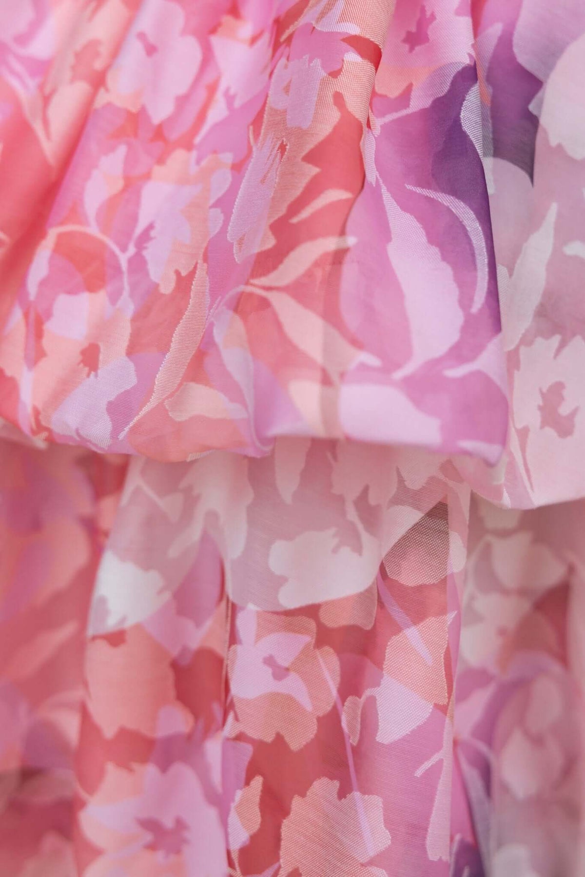 Close-up of floral patterned fabric in shades of pink and purple, showcasing the delicate texture of the Reina Dress.