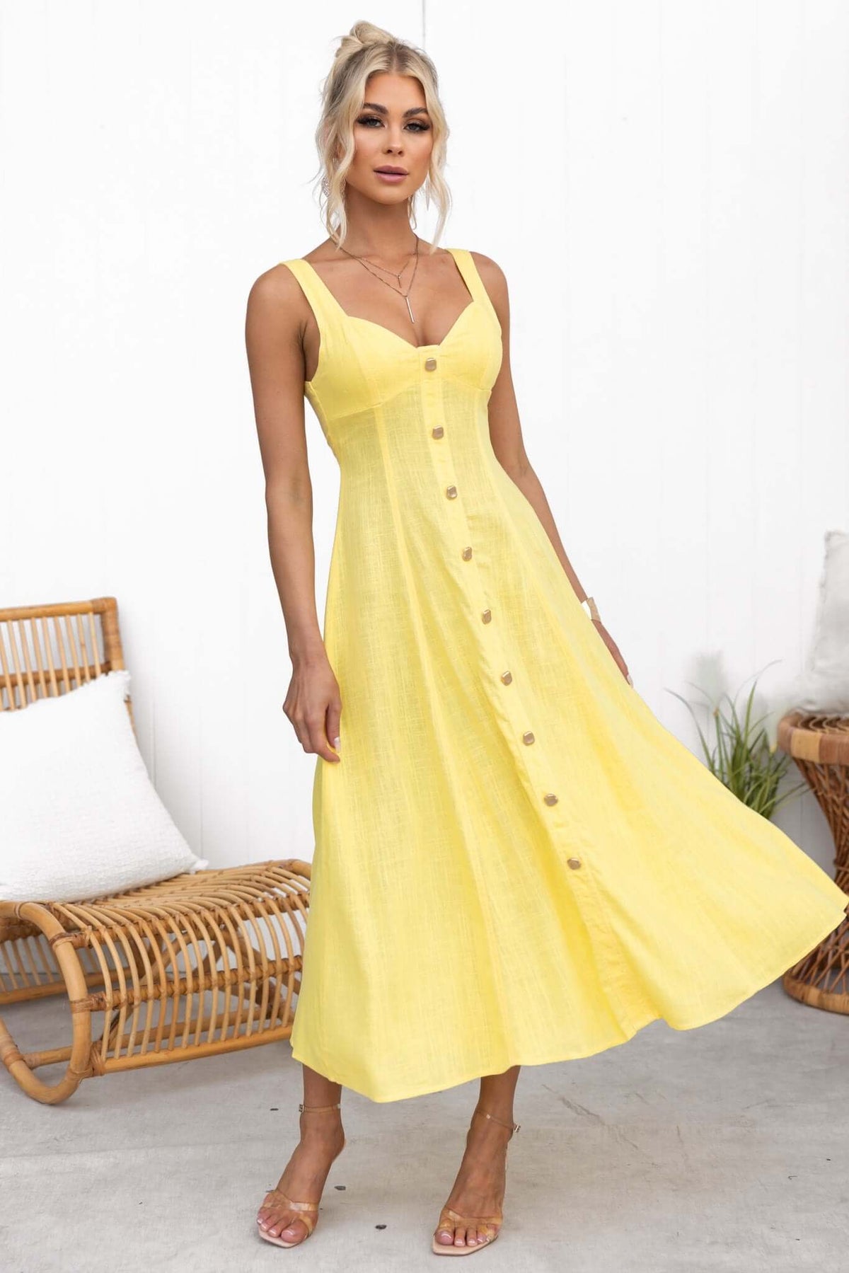 Stylish yellow Lyre Midi Dress featuring faux buttons, a fitted bodice, and a flowing skirt, perfect for any occasion.