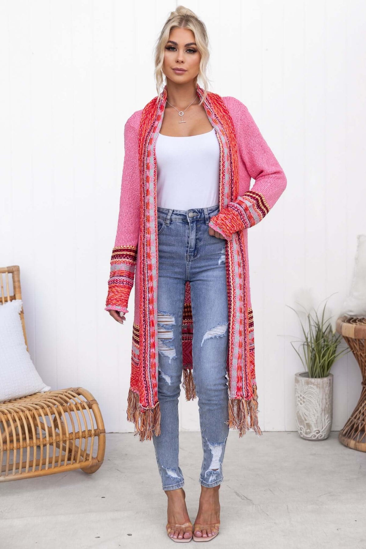 Lewis Cardigan featuring longline fit with tassels, styled with ripped jeans and a white top.