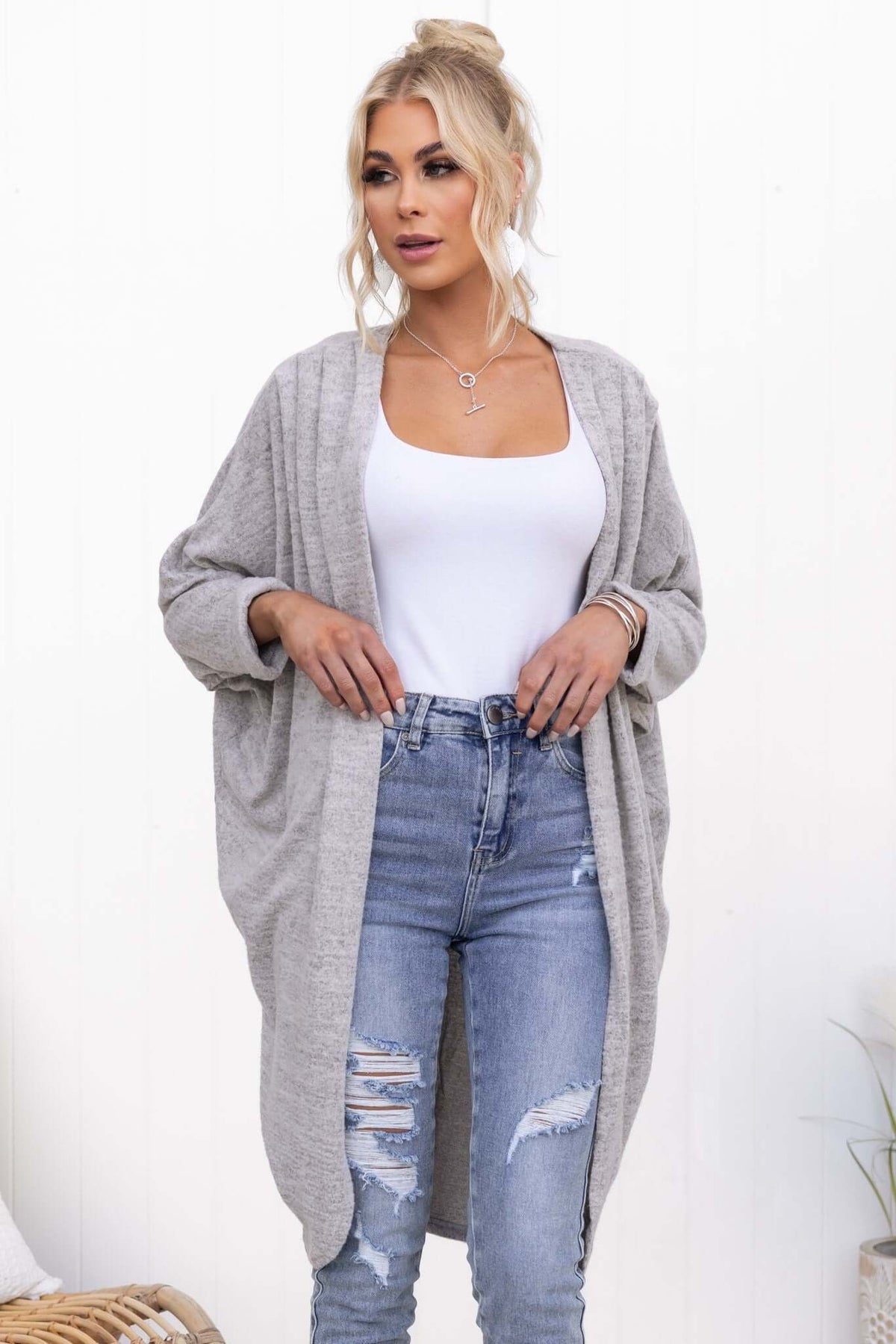 Model wearing a light gray Right Time Cardigan over a white tank top, paired with ripped jeans.