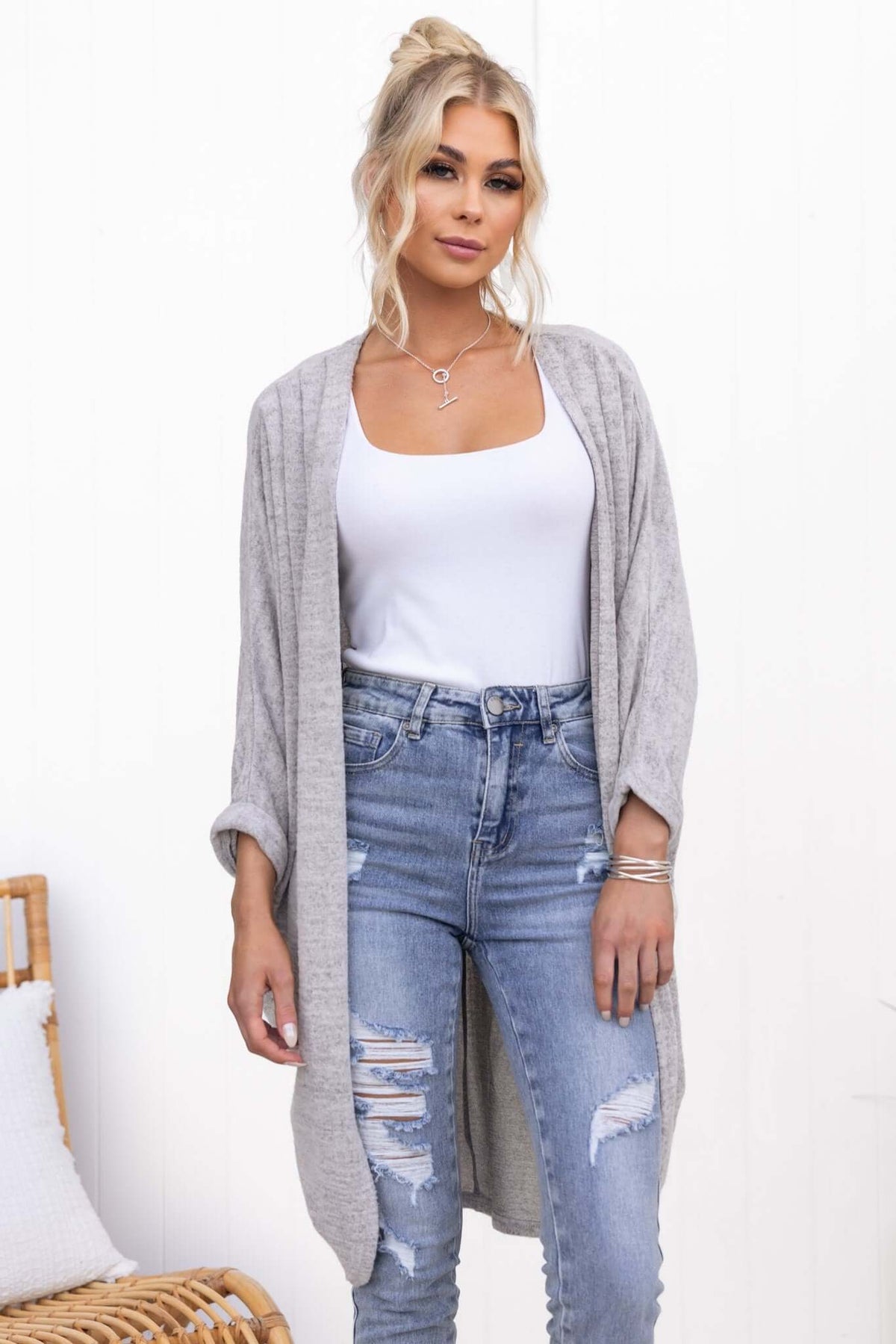 Model wearing the Right Time Cardigan in grey, paired with distressed jeans and a white top, showcasing its soft, relaxed fit.