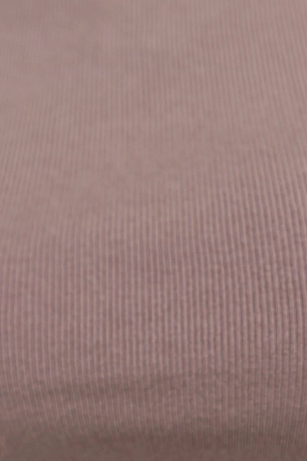 Close-up of ribbed knit fabric in soft mauve color, showcasing texture and stretch suitable for Derby Top.