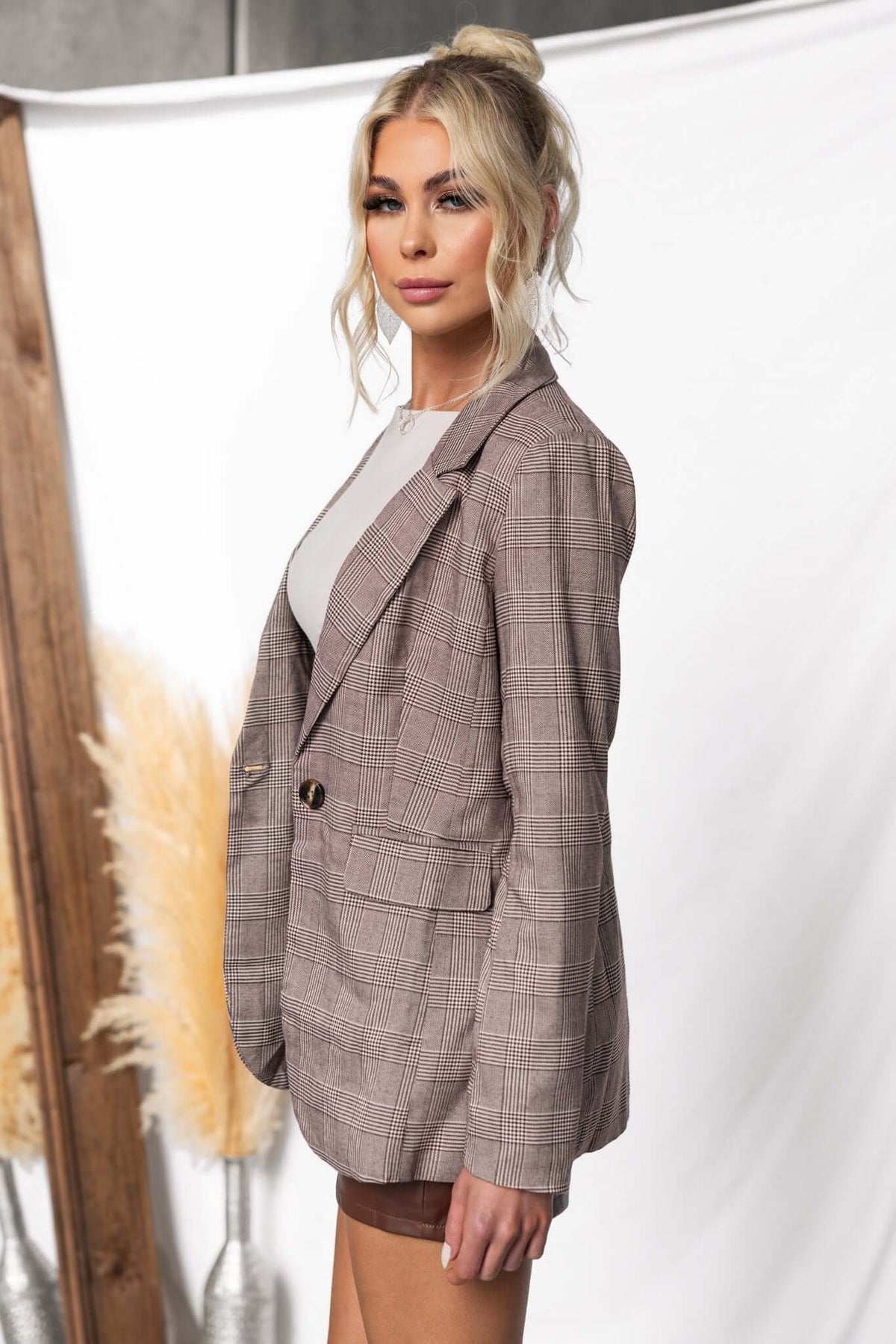 Ingrid Blazer featuring a plaid design, front pockets, and shoulder pads, styled on a model.