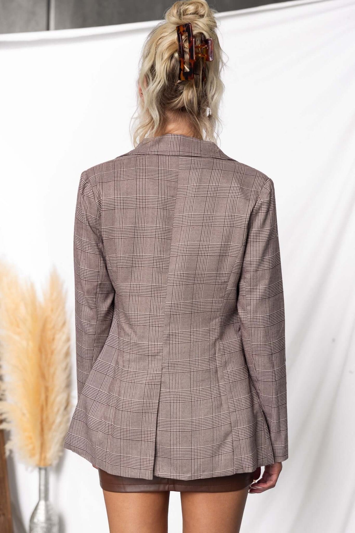 Back view of the Ingrid Blazer showcasing plaid design, shoulder pads, and back split detail against a neutral backdrop.