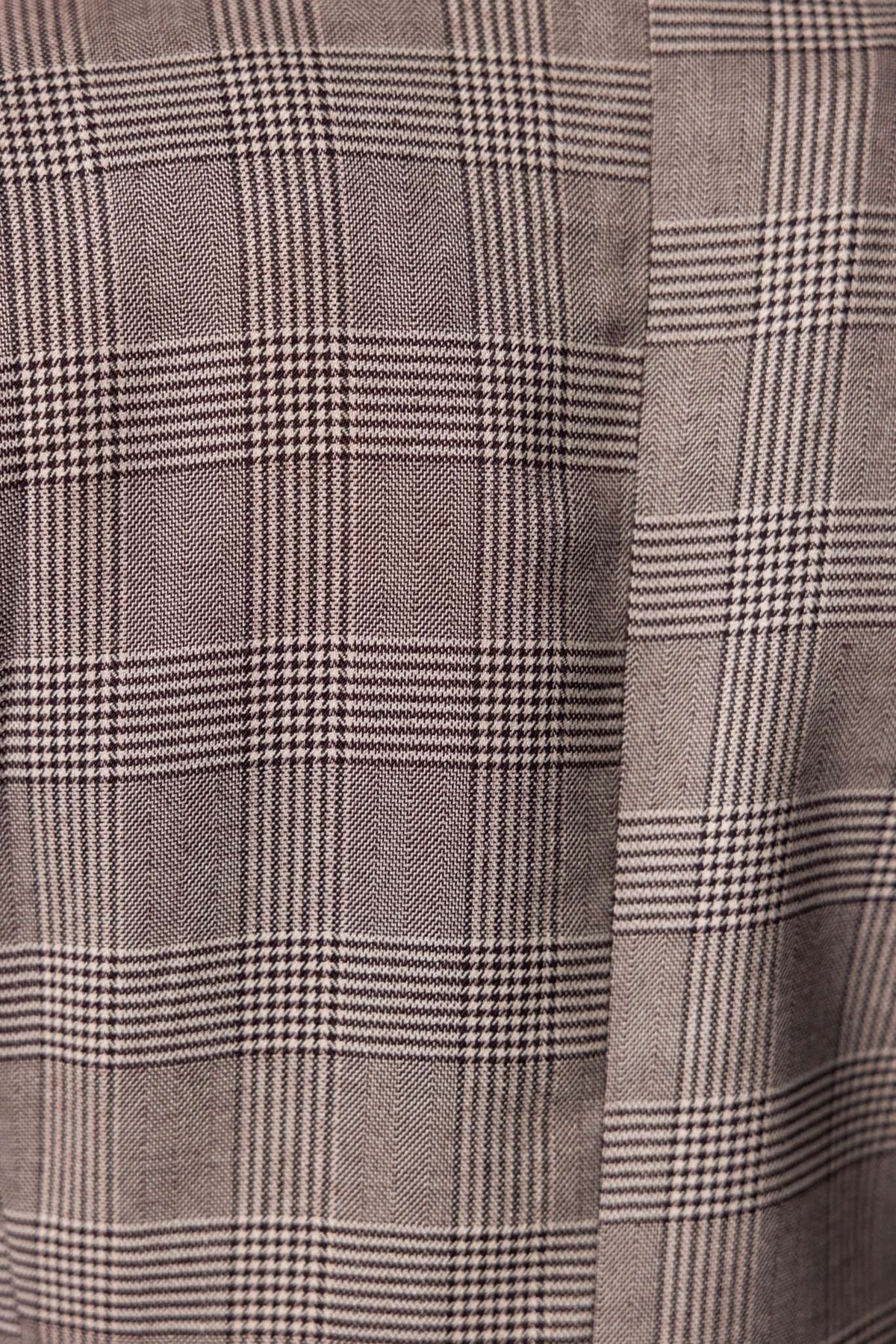 Close-up of Ingrid Blazer fabric featuring a stylish plaid pattern in neutral tones.