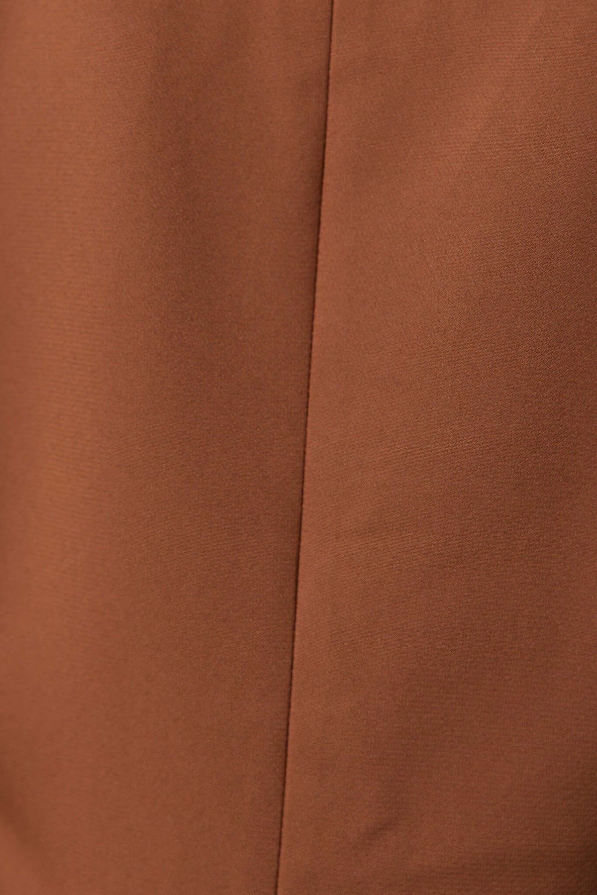 Close-up of the warm brown fabric of the Desio Blazer showcasing its smooth texture and clean stitching.