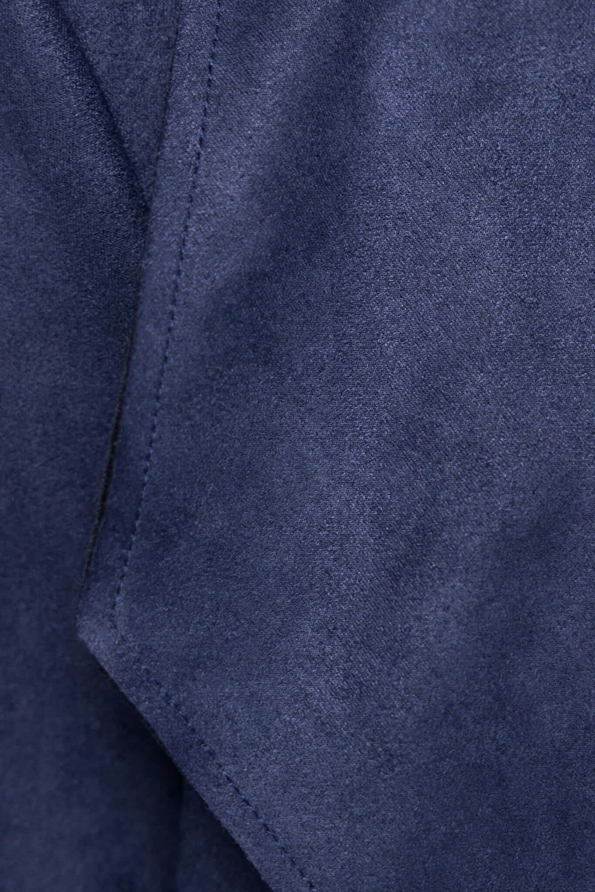 Close-up of navy blue faux suede fabric showcasing draping detail for Hayley Coat.