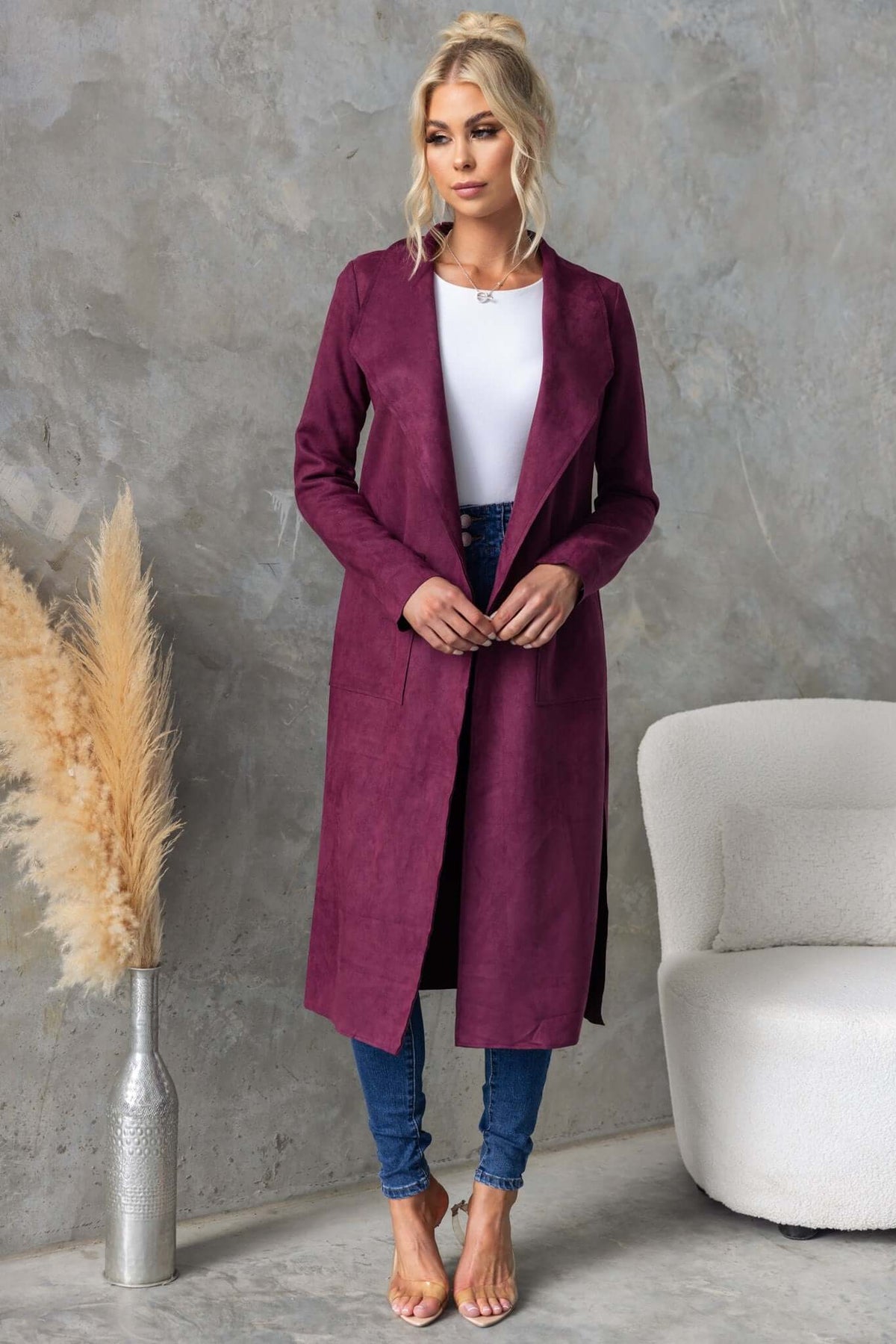 Hayley Coat in burgundy with draping lapel, longline fit, worn by a model with blue jeans and heels.