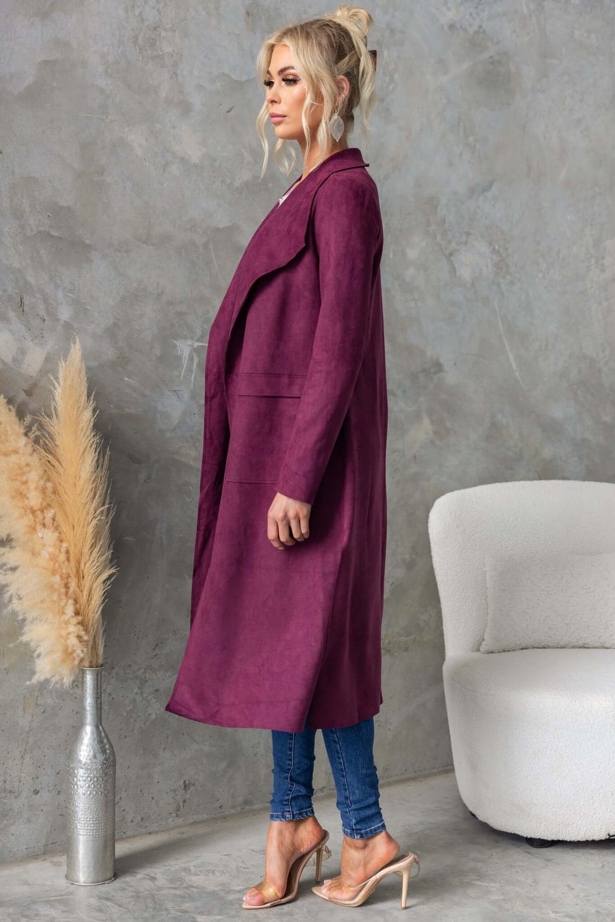 Longline Hayley Coat in suede feel, featuring draping lapel and side slits, styled with slim jeans and heels.