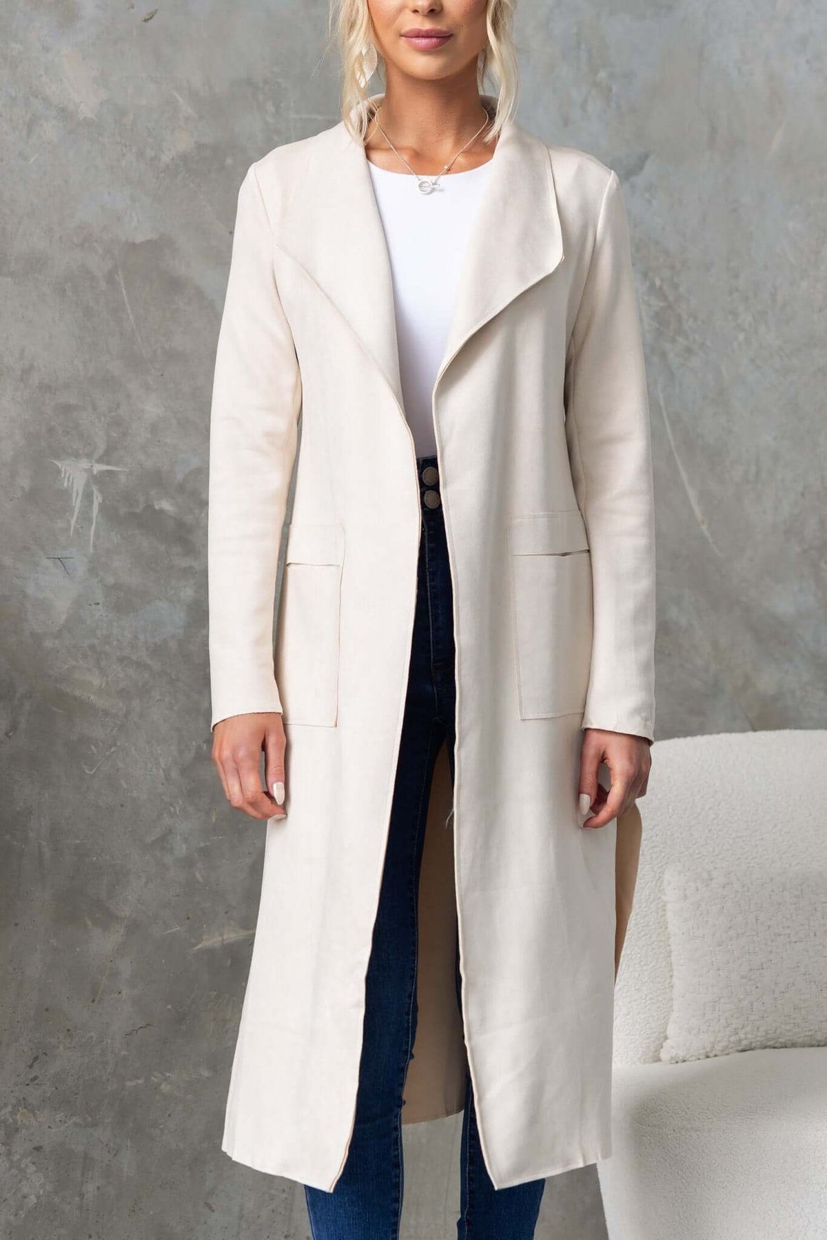 Hayley Coat in cream with draping lapel, high slits, and pockets; perfect for a stylish longline fit.