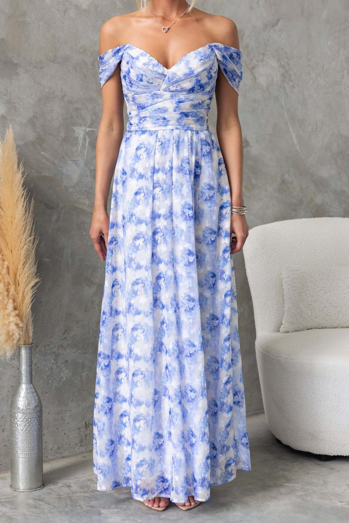 Joan Maxi Dress featuring an off-shoulder design, floral pattern, and flowing chiffon fabric, ideal for special occasions.