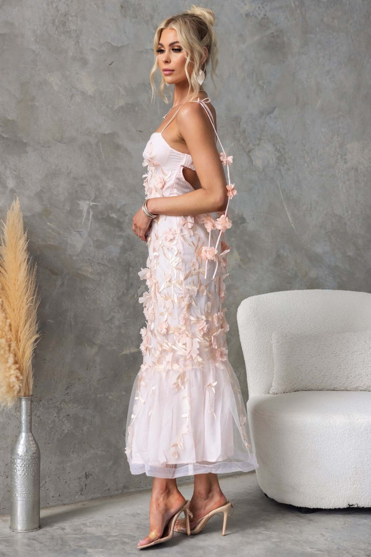 Nephi Midi Dress featuring lace overlay, adjustable tie straps, and elegant floral embroidery in soft pink.