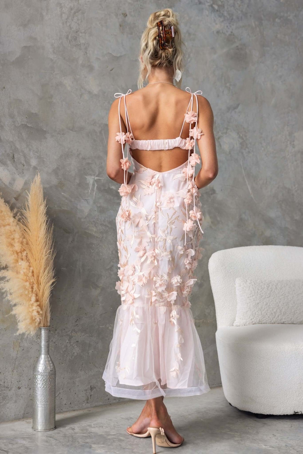 Back view of Nephi Midi Dress featuring adjustable straps and lace overlay in soft pink.