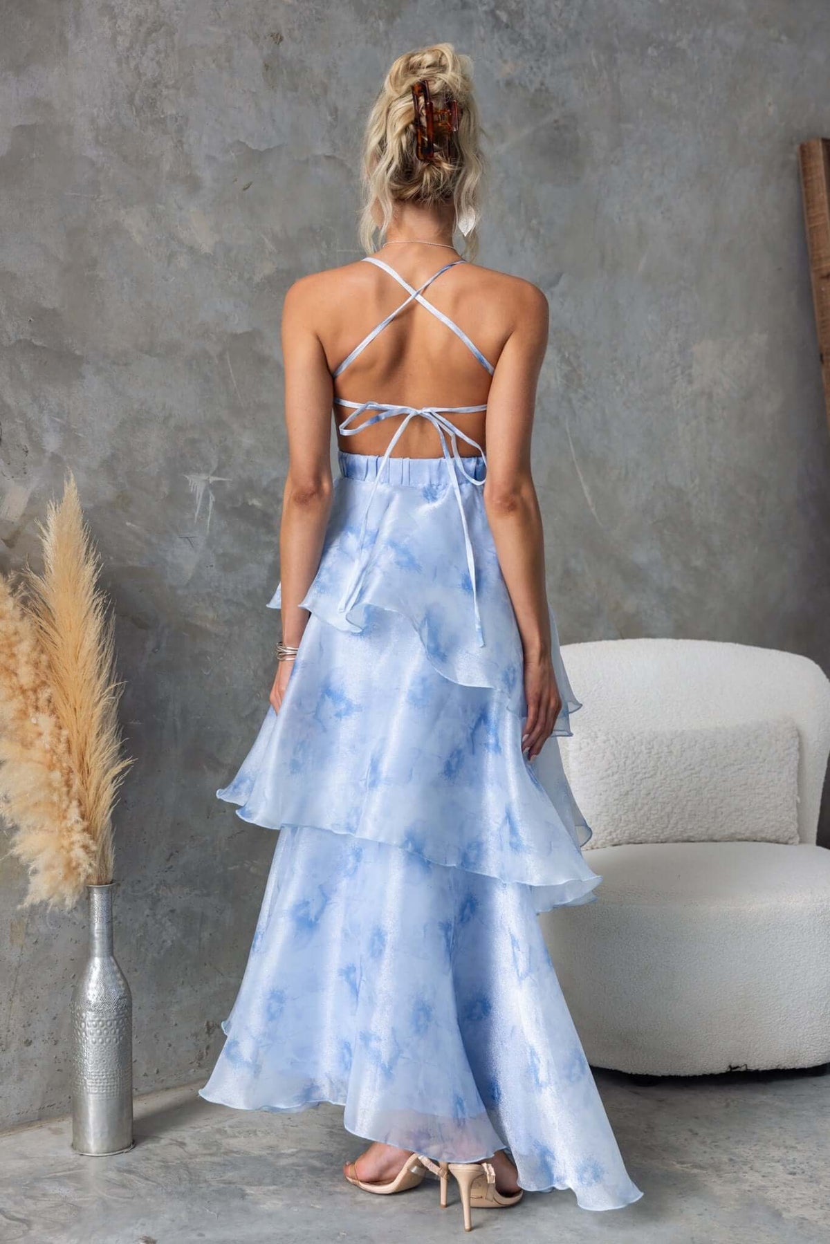 Back view of Kirsti Maxi Dress with adjustable tie straps and ruffle skirt in light blue chiffon.