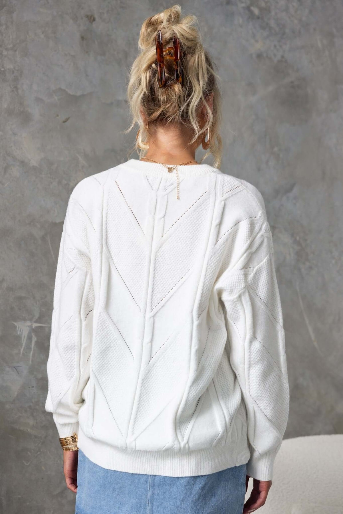 Back view of Becker Jumper, featuring a round neckline and cable knit design in a soft white color.
