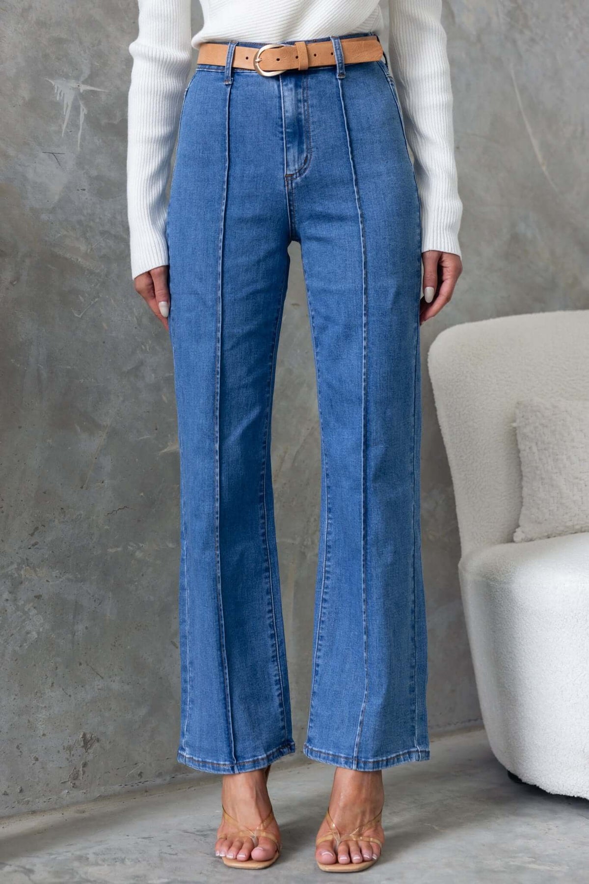 Daffy Jeans featuring mid-high waist, wide legs, and a stylish belt, perfect for a chic casual look.