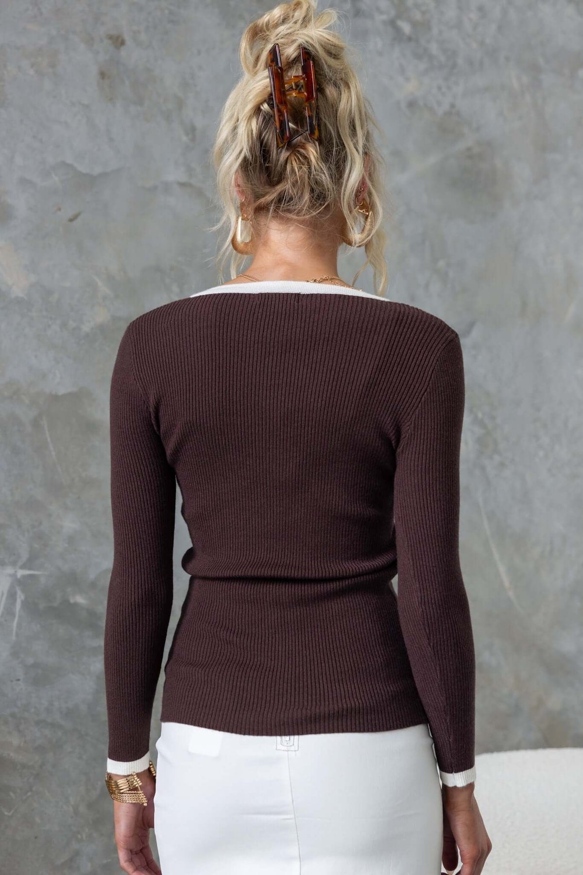 Back view of the Brydie Top showcasing ribbed knit fabric, round neckline, and long sleeves in a stylish brown color.
