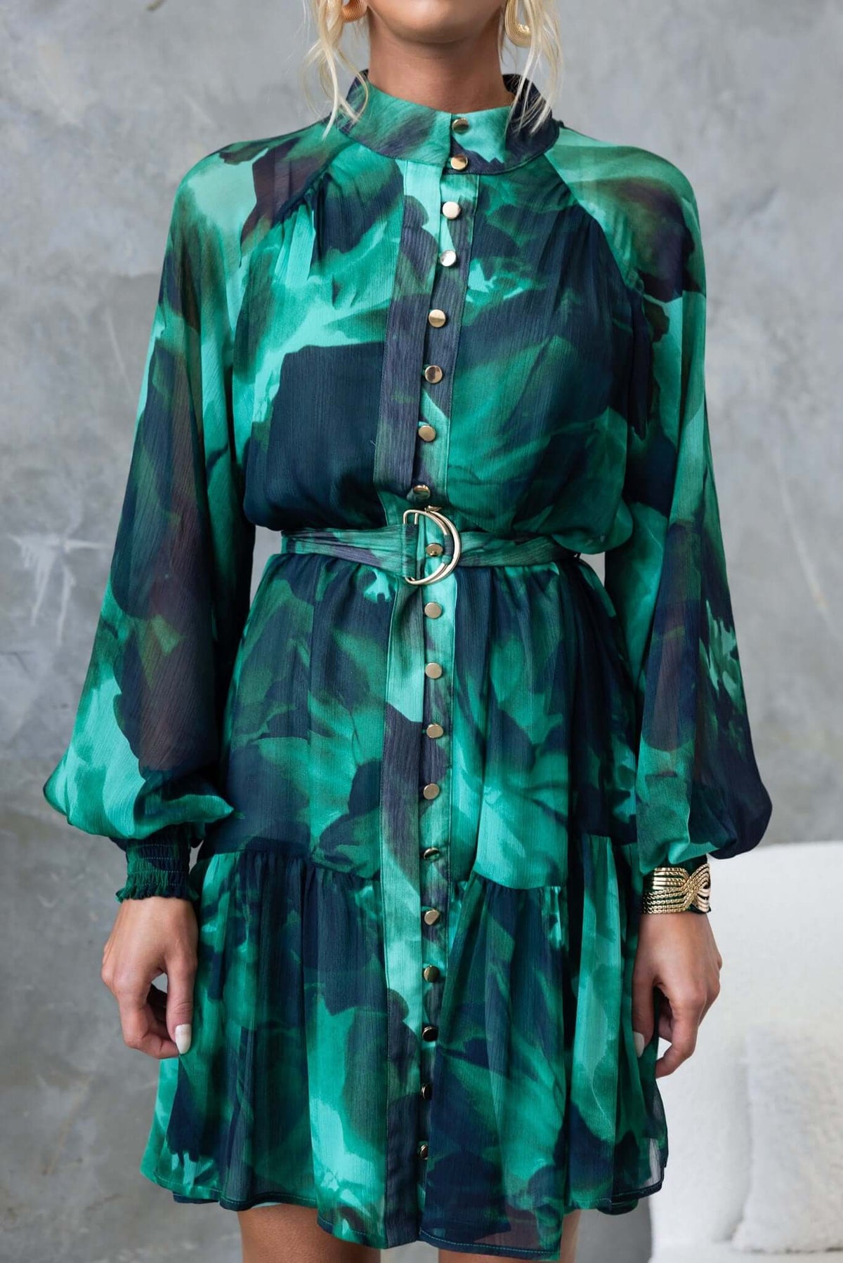 Orazio Dress featuring a high neckline, button-up front, and removable belt in vibrant green chiffon patterns.