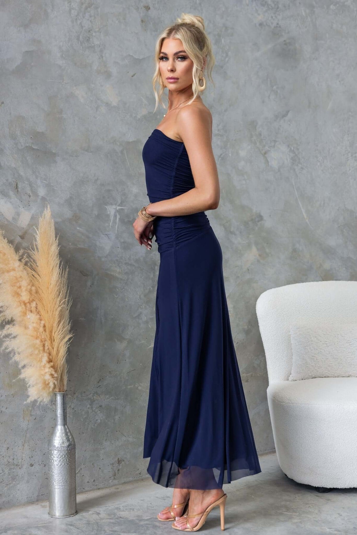 Elegant navy Legrand Maxi Dress, strapless with a front split, showcased by a model in a stylish setting.