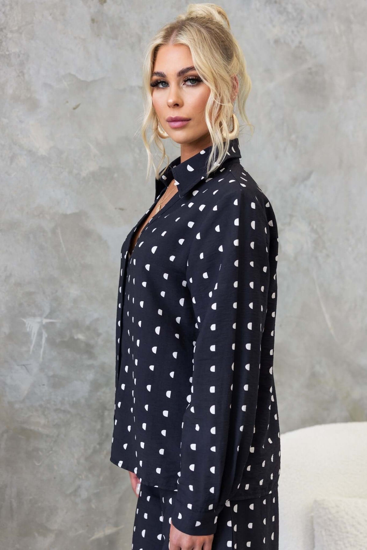 Stylish black Marion Shirt with white heart pattern, featuring a button-up front and a standard fit.