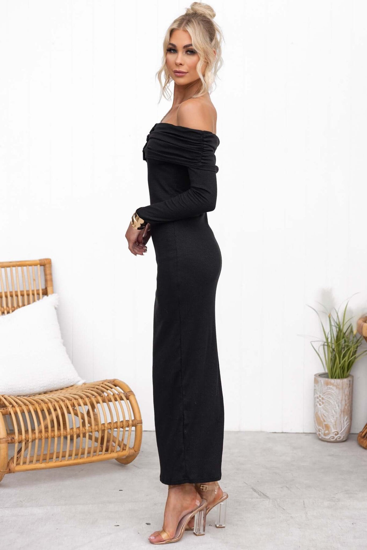 Judah Maxi Dress in black, off-shoulder style, featuring faux buttons and a fitted ribbed design, showcased by a model.