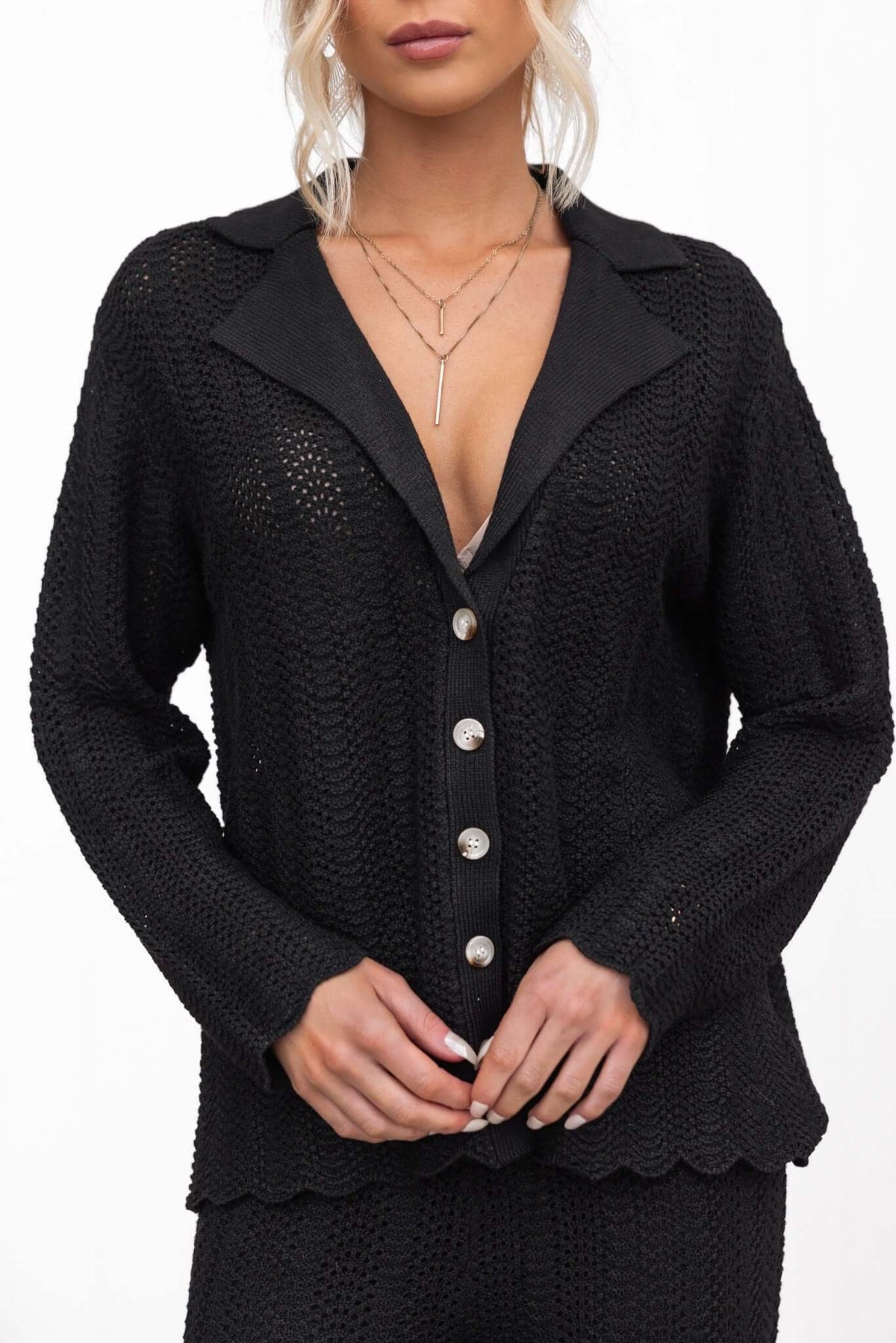 Model wearing a black Moline Shirt featuring a button-up front, knit material, and relaxed fit.