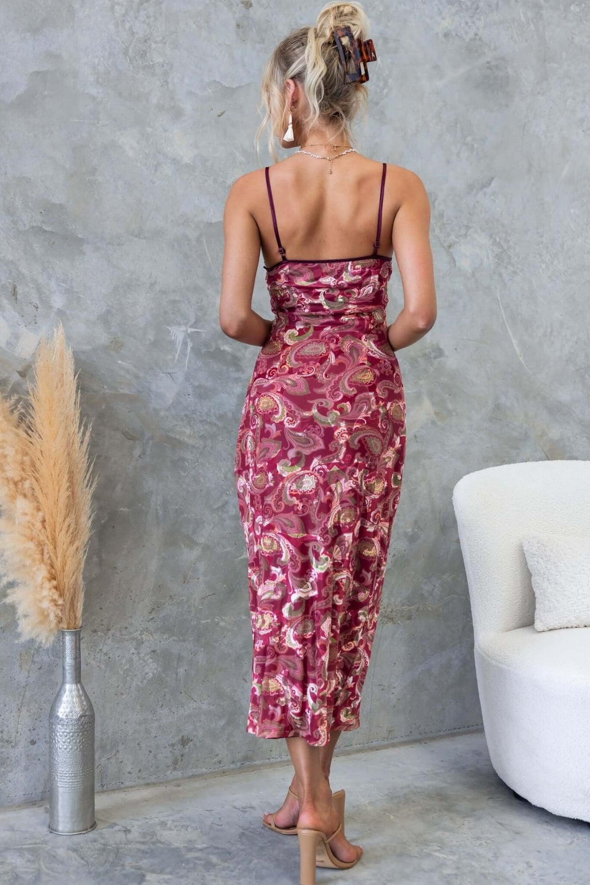 Model wearing the Poet Maxi Dress with adjustable straps, featuring a floral pattern and a form-fitting silhouette.