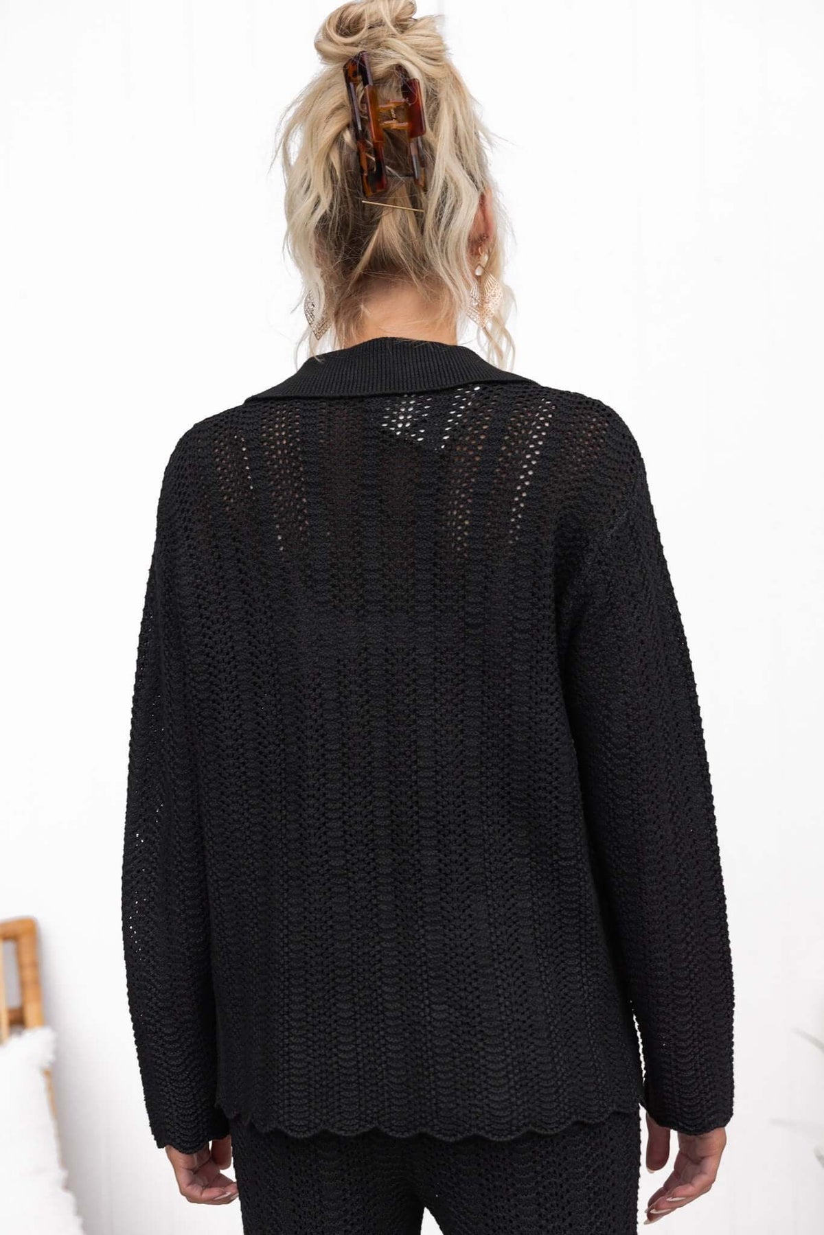 Back view of a black Moline Shirt featuring a knit material, collar, and relaxed fit.