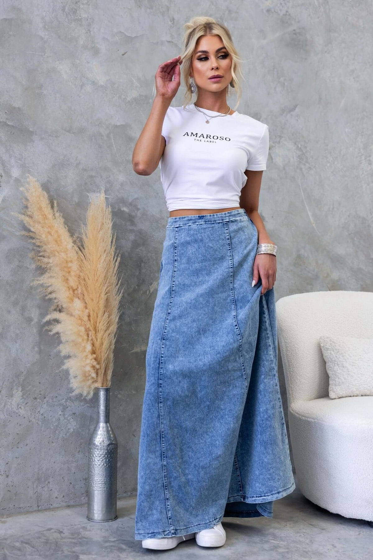 Model wearing a Jacquie Denim Maxi Skirt with a white crop top, showcasing a stylish mid-high waist design.