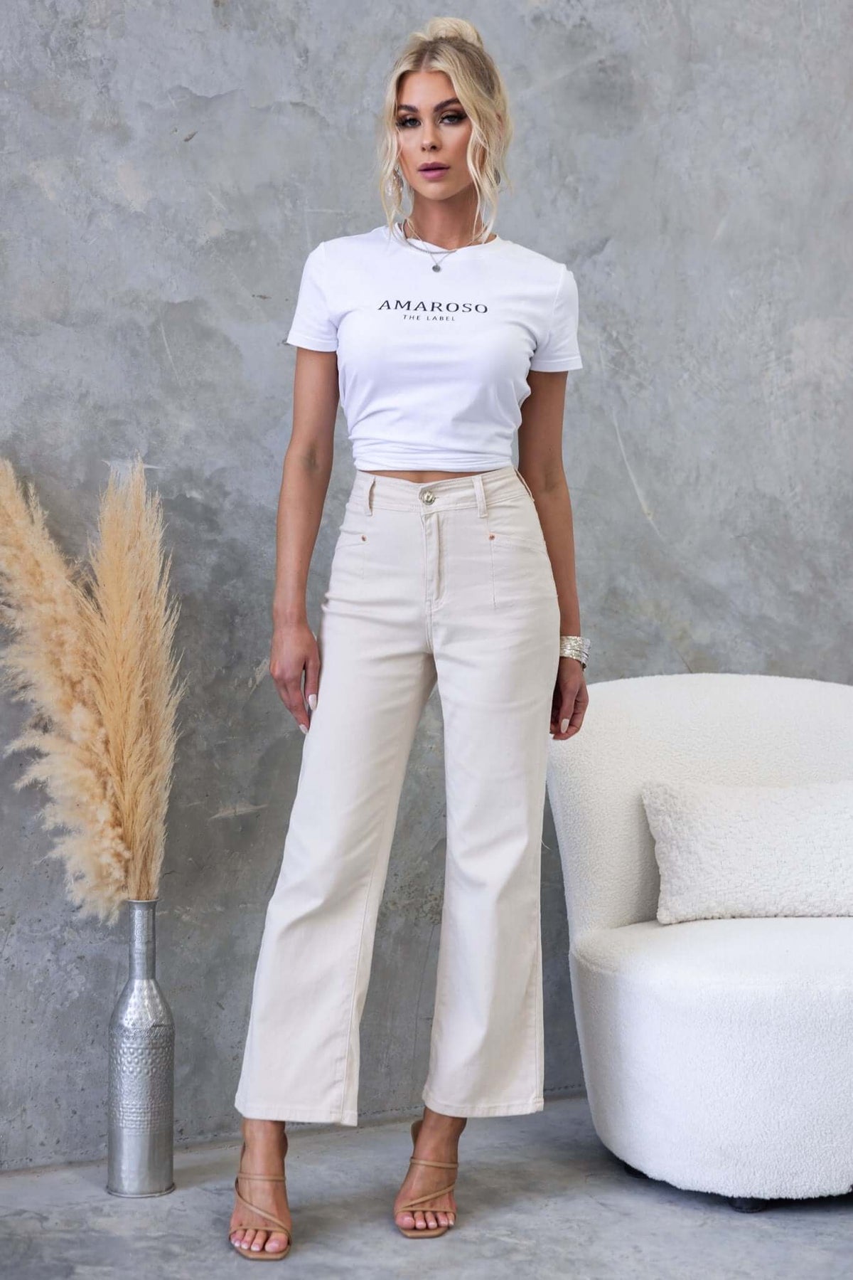 Model wearing Blanca Jeans with wide legs and mid-high waist, styled with a white Amaroso tee.