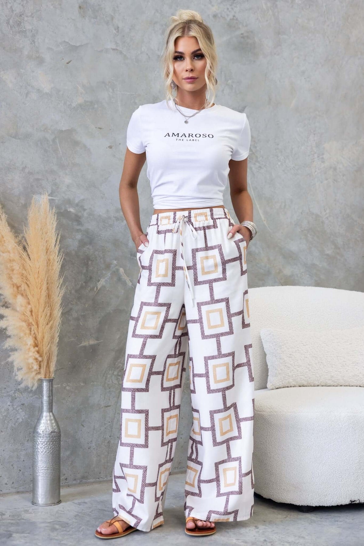 Aiden Pants featuring a mid-high waist fit, elastic drawstring waistband, and geometric patterns for a stylish look.