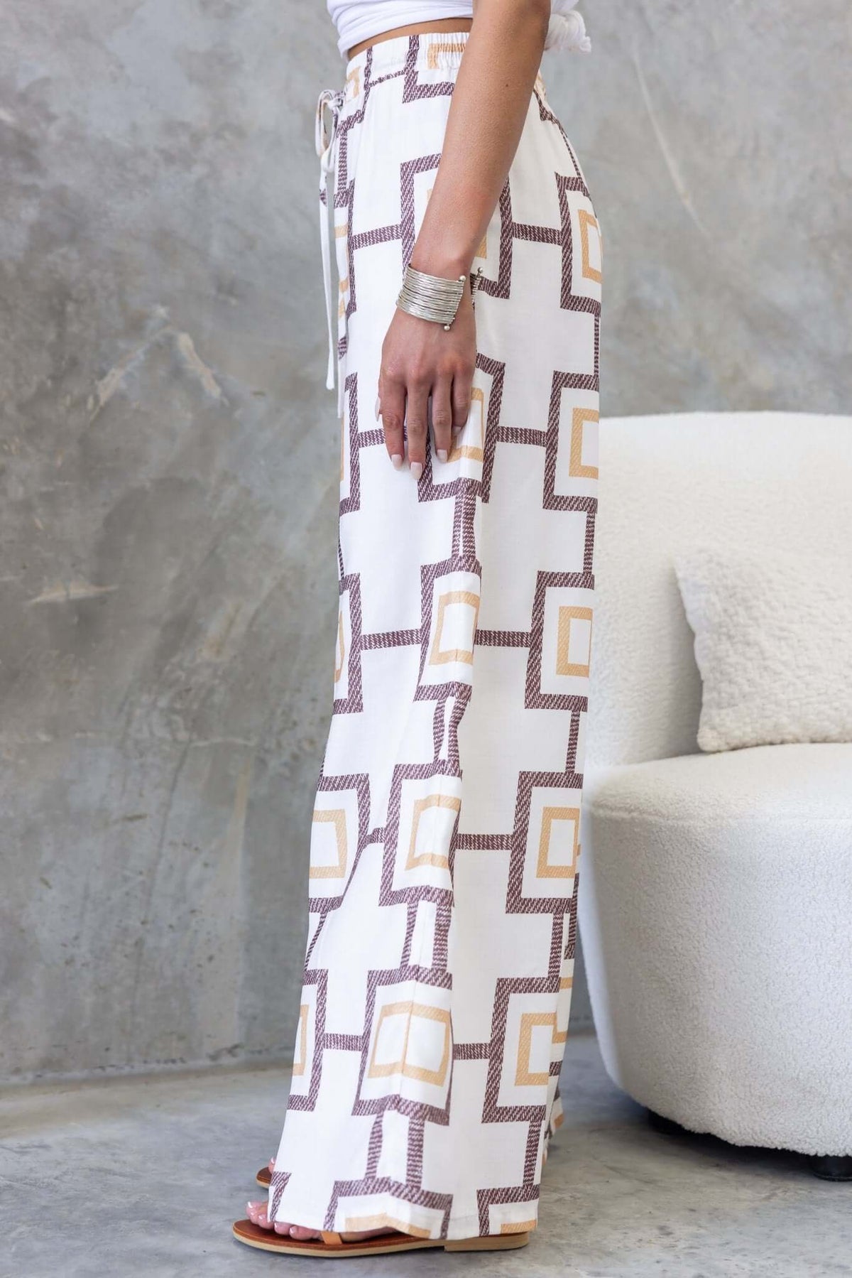 Aiden Pants featuring a high-waist fit, elastic waistband, and geometric print, styled on a model.