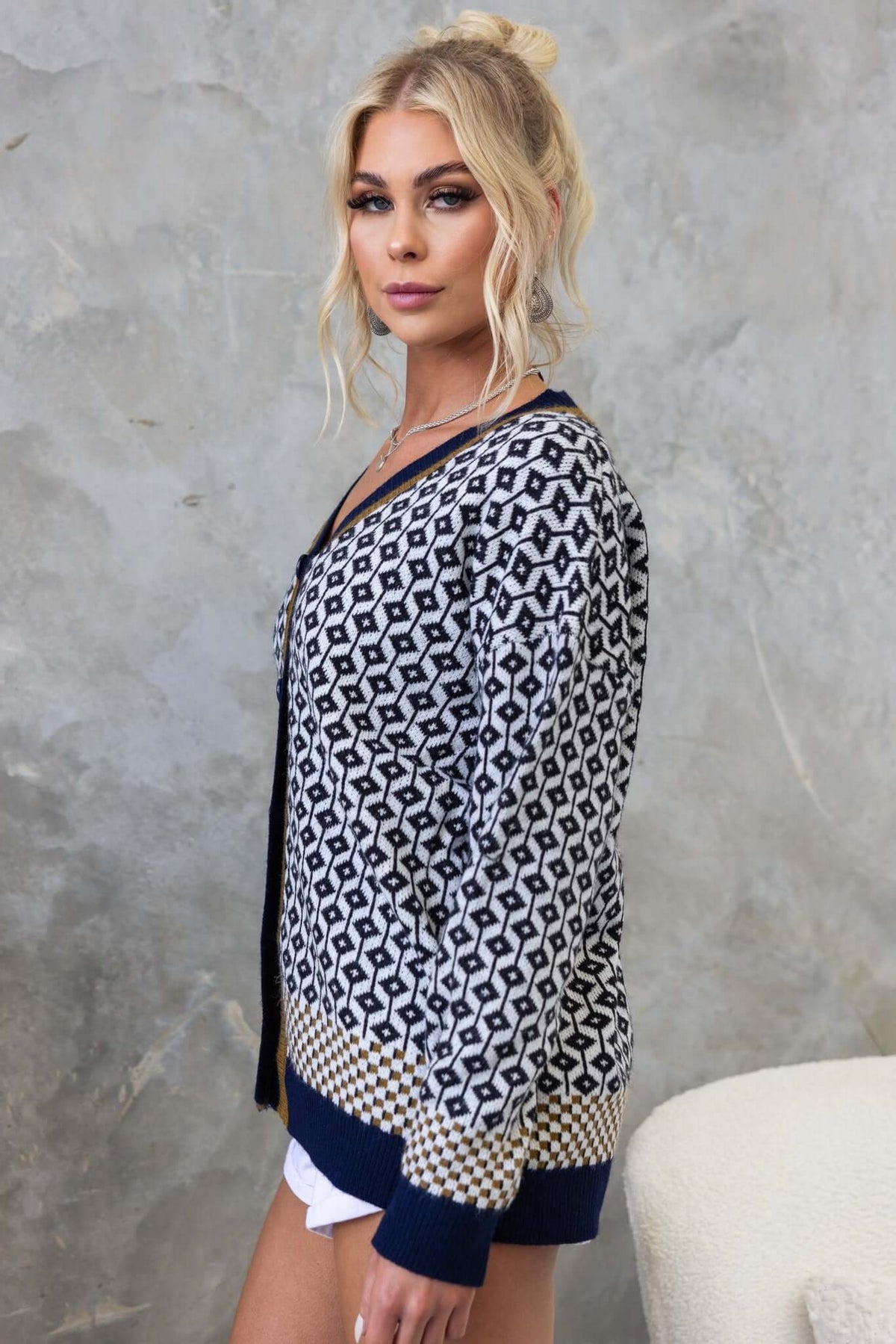 Model showcasing the Clanton Cardigan with V-neckline and button-up front, featuring a stylish knit pattern.