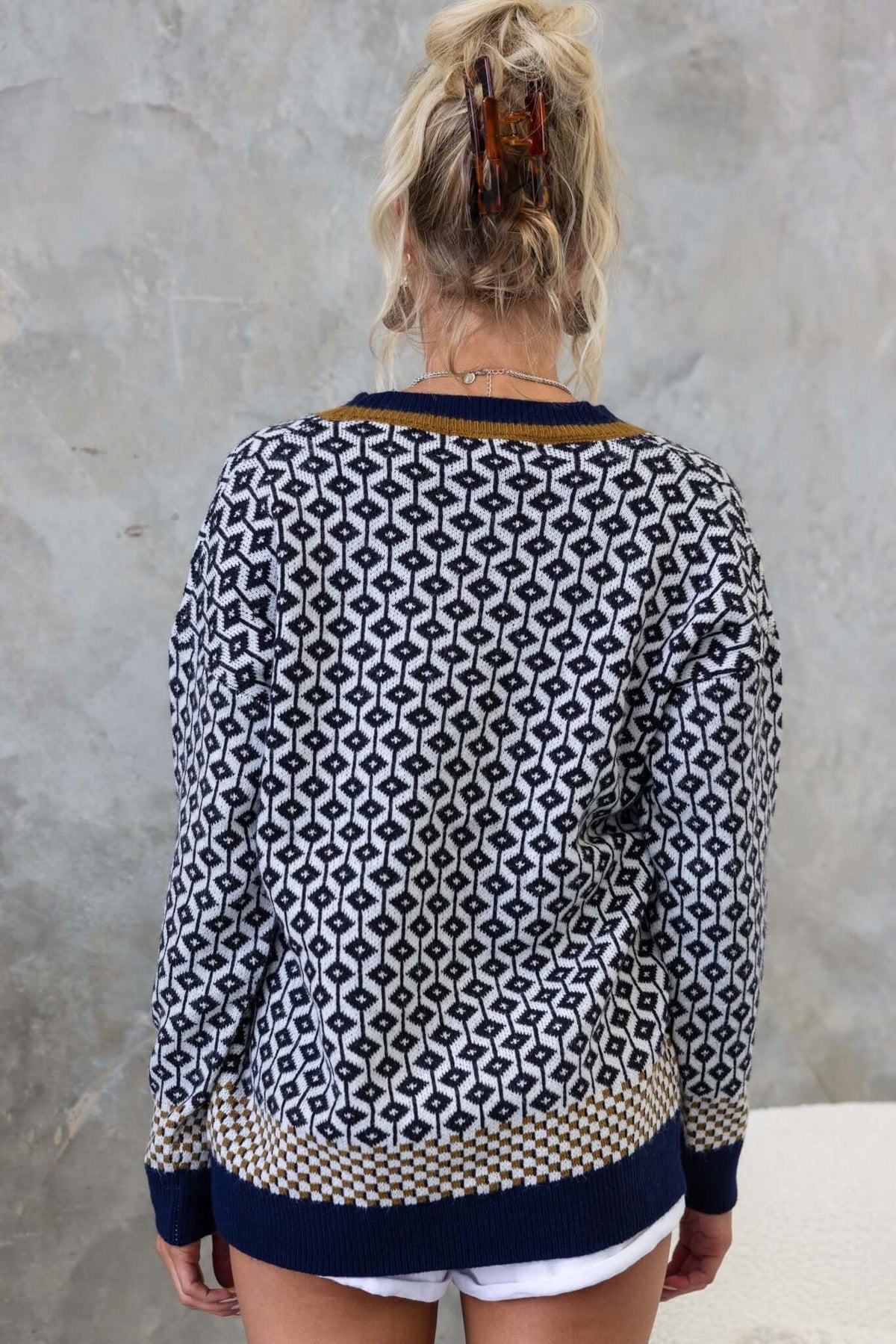Back view of Clanton Cardigan featuring a unique pattern, relaxed fit, and cozy knit material.