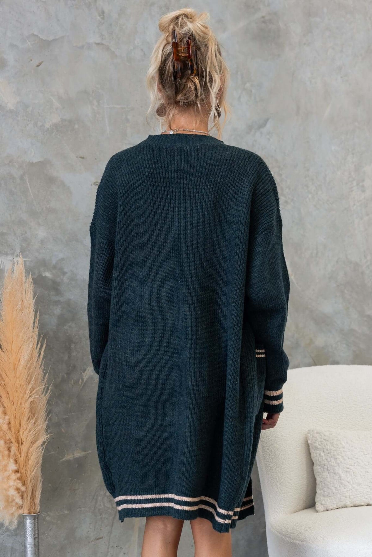 Back view of a longline dark green cardigan with stripes, featuring a relaxed fit and cozy knit material.