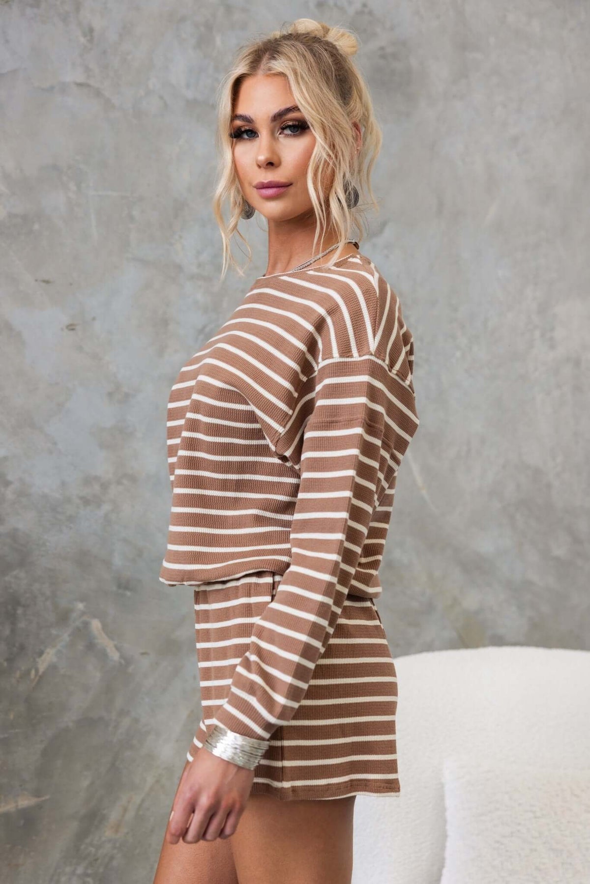 Woman in striped brown East Coast jumper with a round neckline, showcasing a relaxed fit style.
