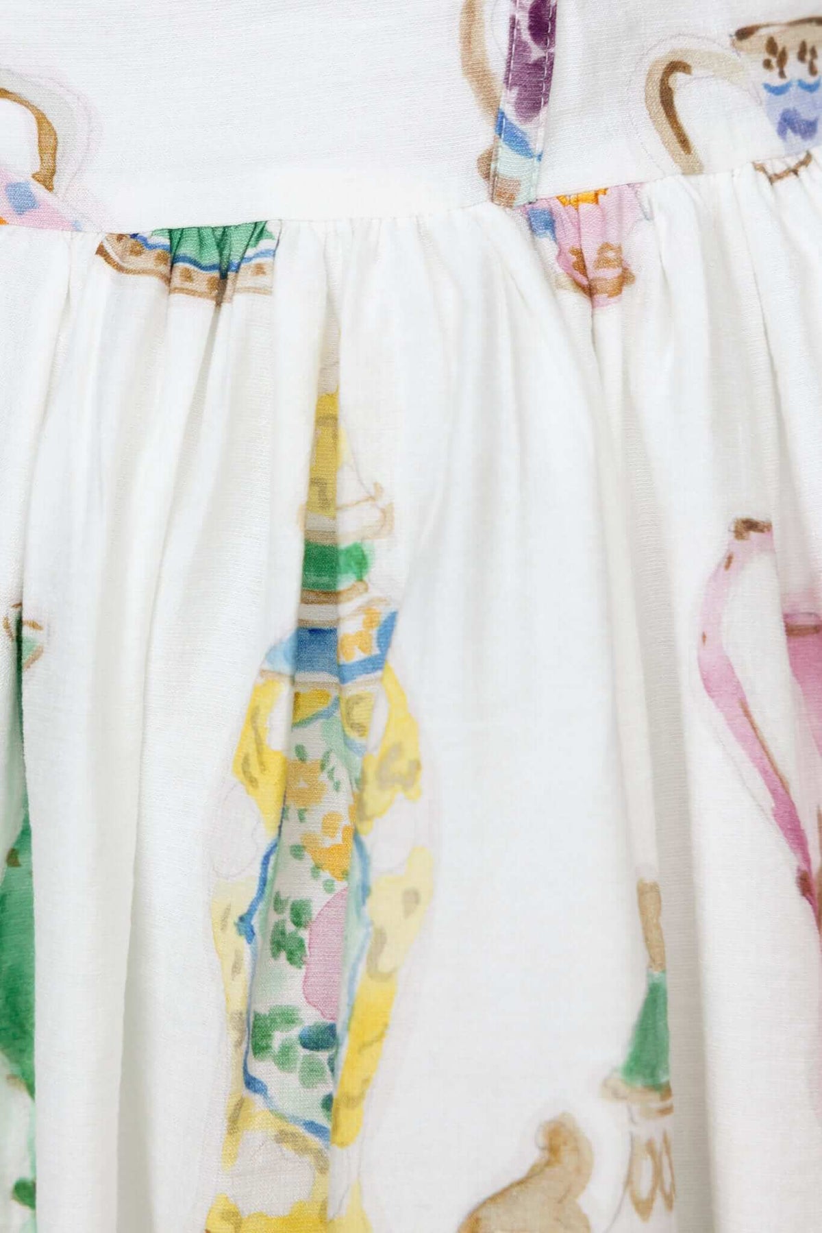 Close-up of Care Free Dress featuring colorful hand-painted designs on soft fabric with adjustable straps.