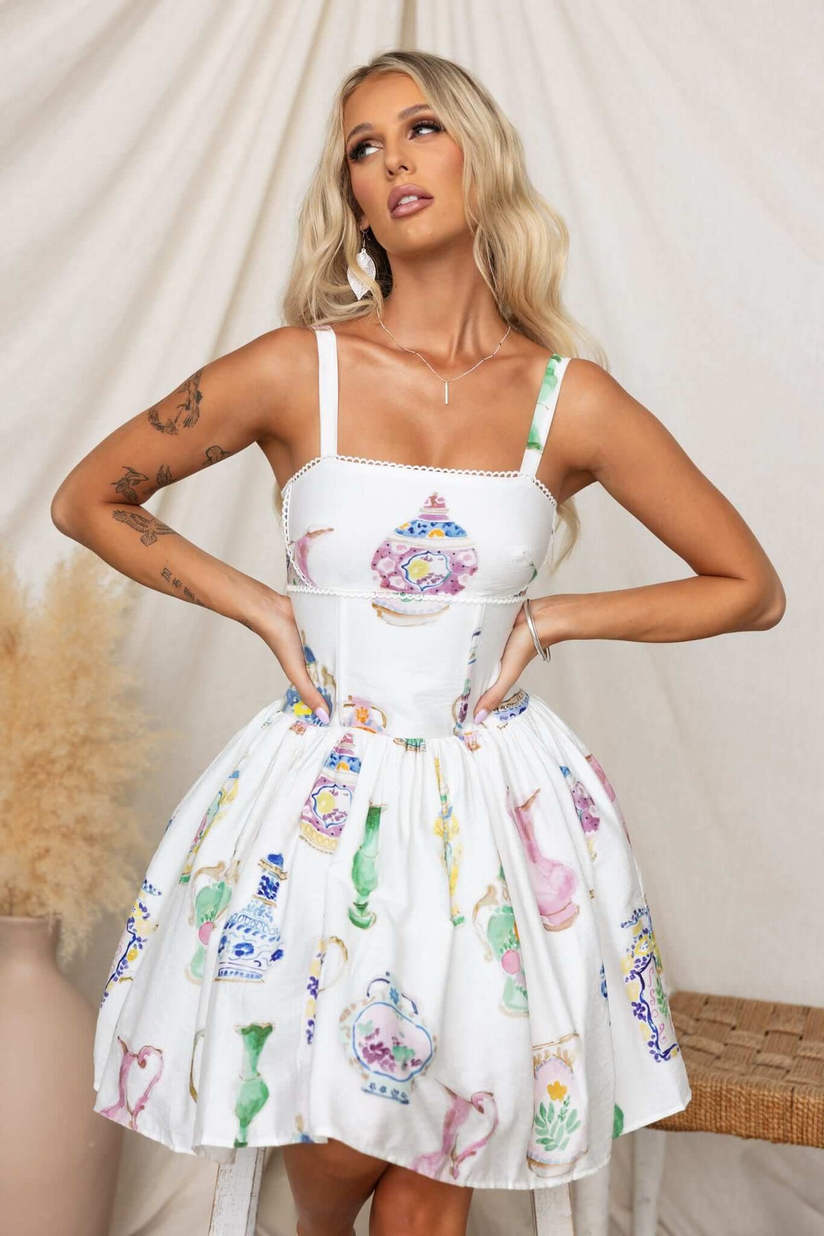 Model wearing a Care Free Dress with adjustable straps and colorful vase print, featuring a flared skirt and tulle underlay.