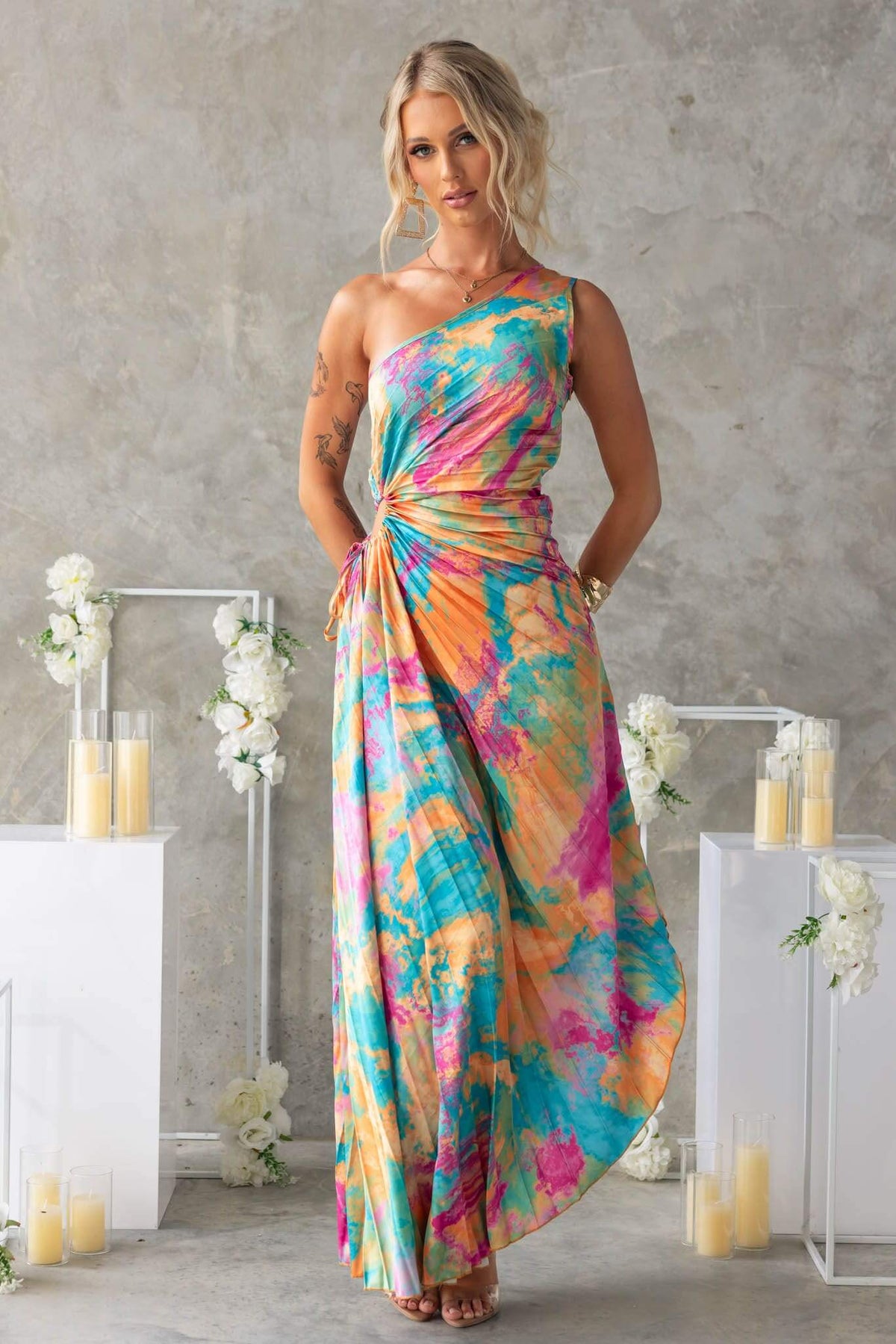 Colorful Tejano maxi dress featuring a one-shoulder neckline and stylish cut-out at the waist, perfect for summer events.